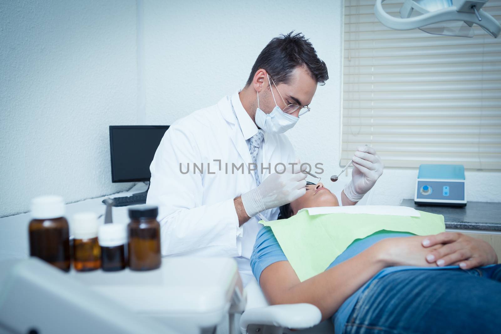 Male dentist examining womans teeth by Wavebreakmedia