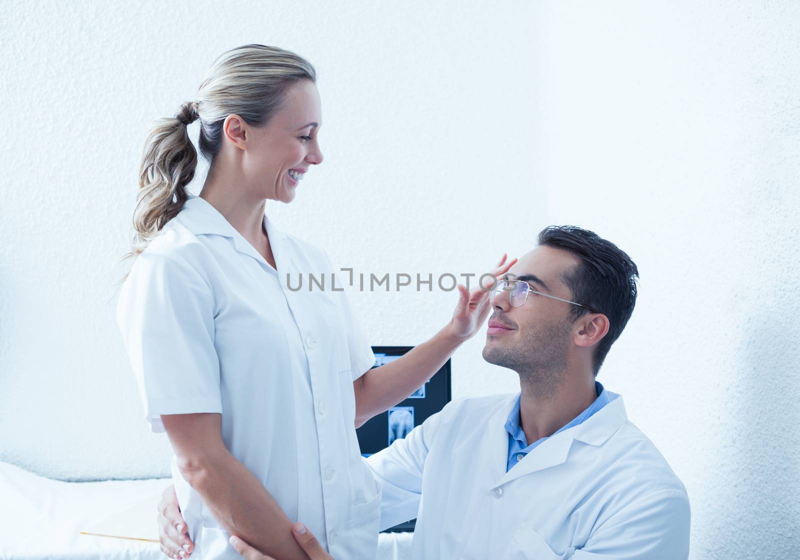 Young male and female dentists looking at each other