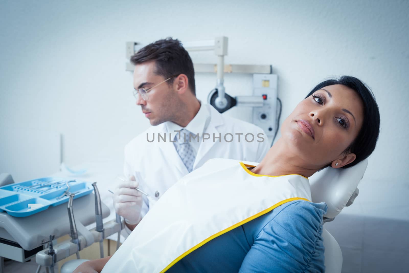 Portrait of serious young woman waiting for a dental exam