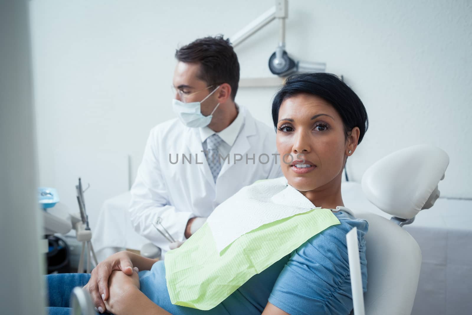 Portrait of serious young woman waiting for a dental exam