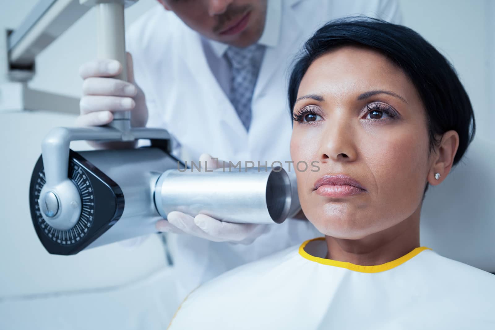 Serious young woman undergoing dental checkup by Wavebreakmedia