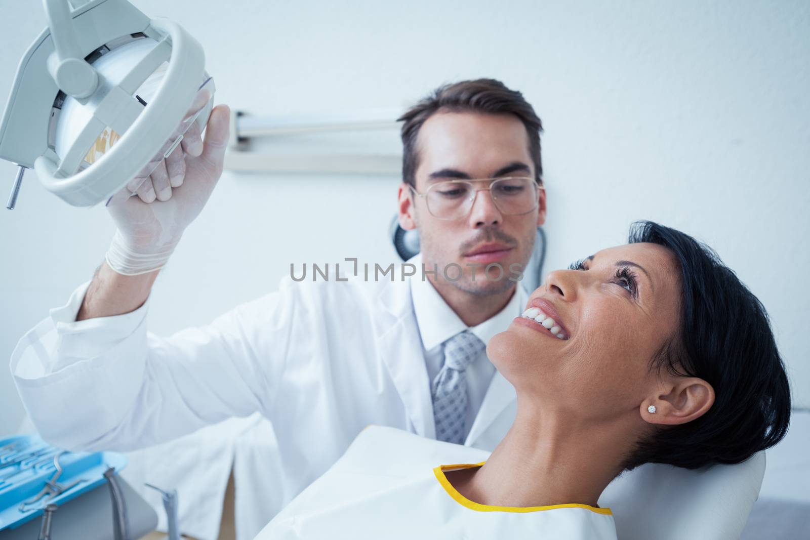 Side view of smiling young woman waiting for a dental exam