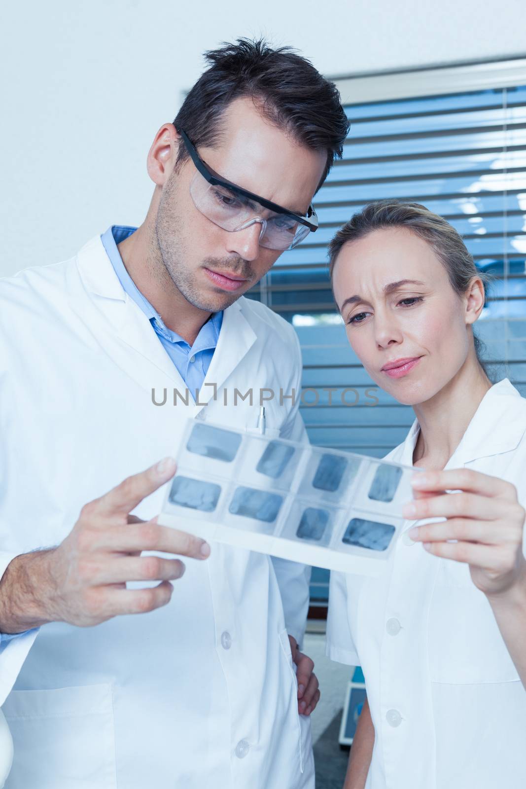 Two concentrated dentists looking at x-ray