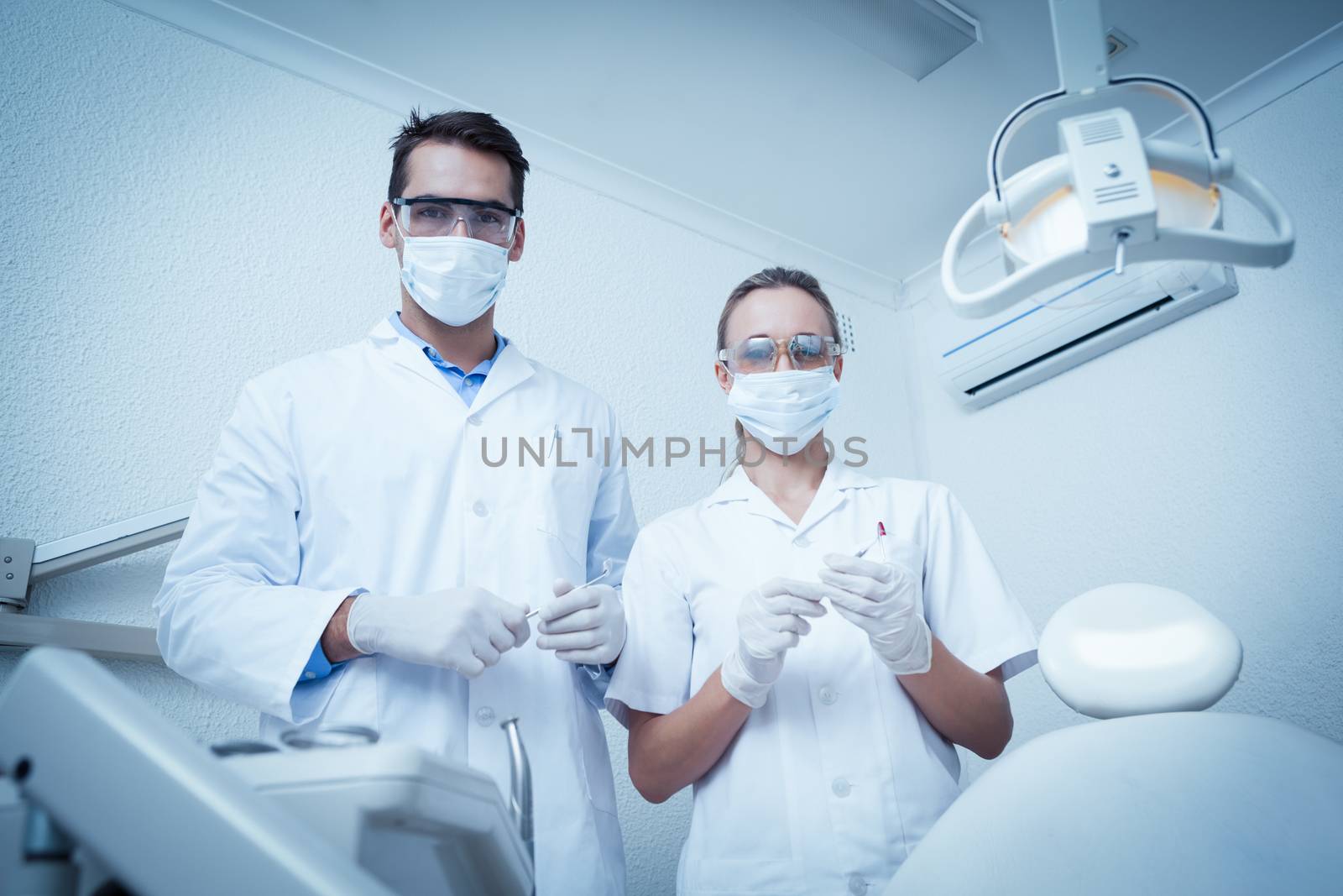 Portrait of male and female dentists wearing surgical masks