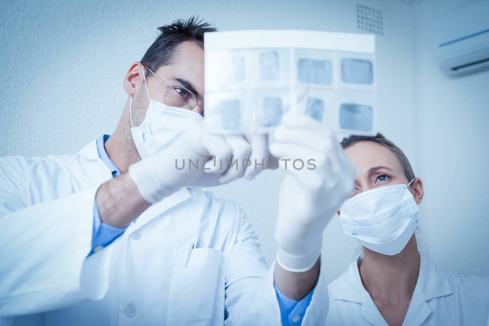 Dentists looking at x-ray by Wavebreakmedia
