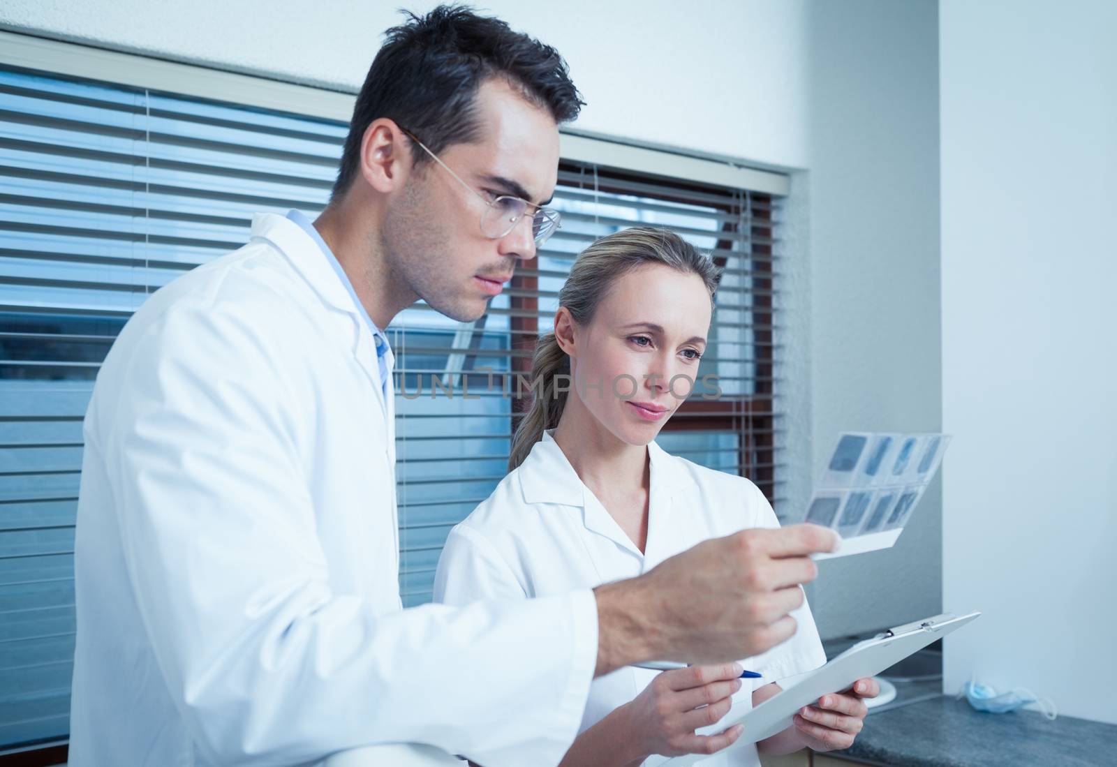 Two concentrated dentists looking at x-ray