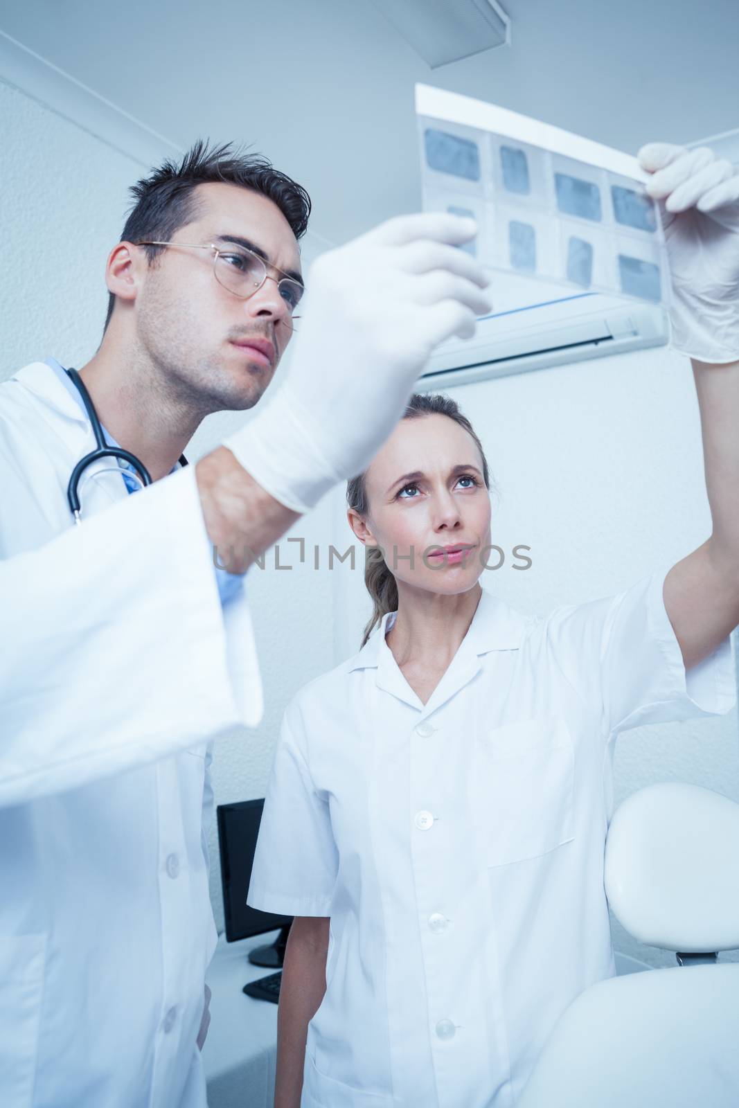 Concentrated two dentists looking at x-ray