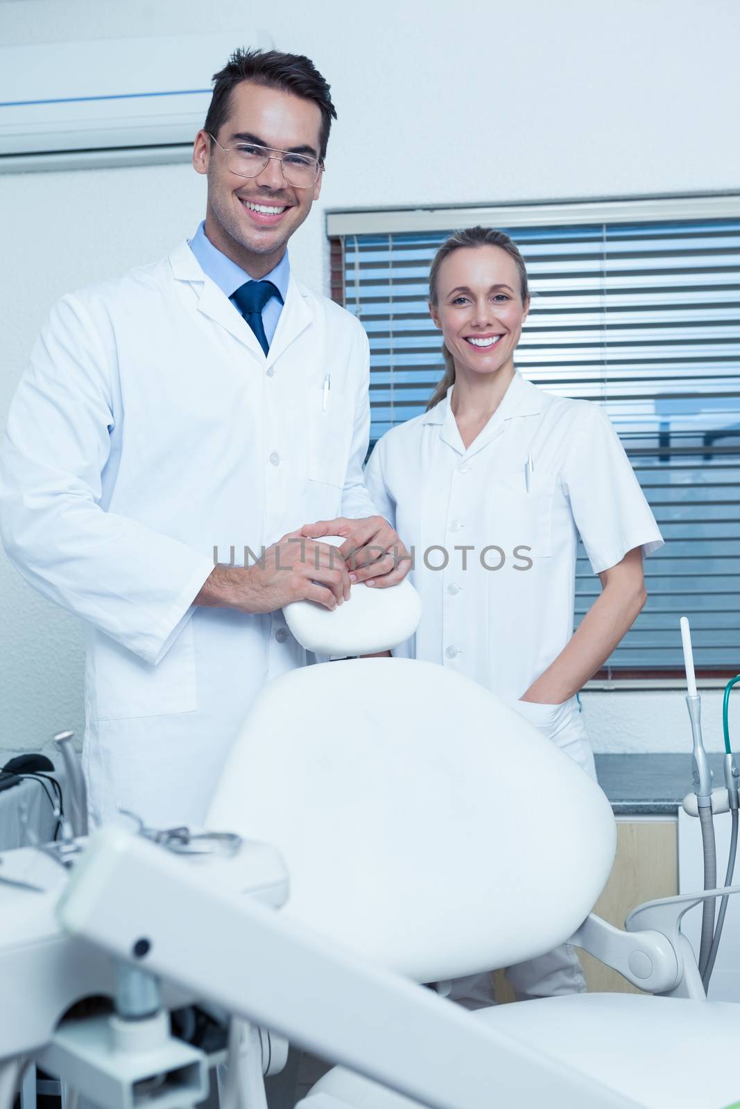 Portrait of smiling male and female dentists