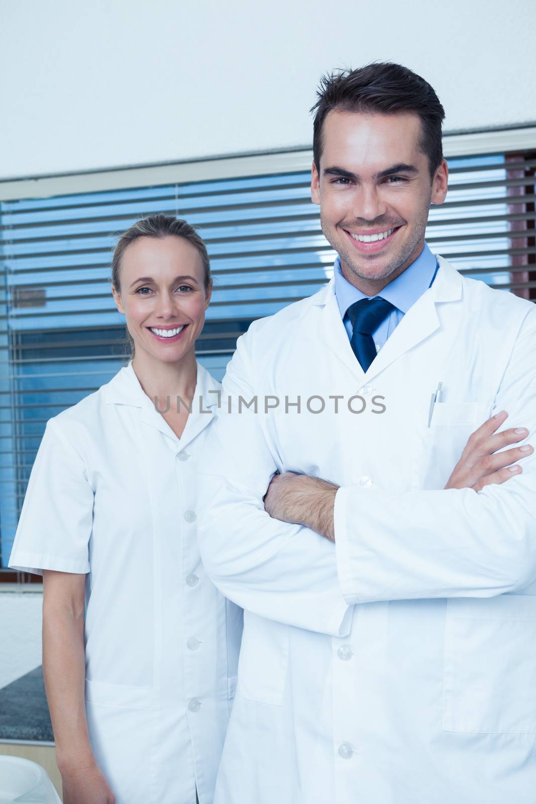 Portrait of smiling male and female dentists