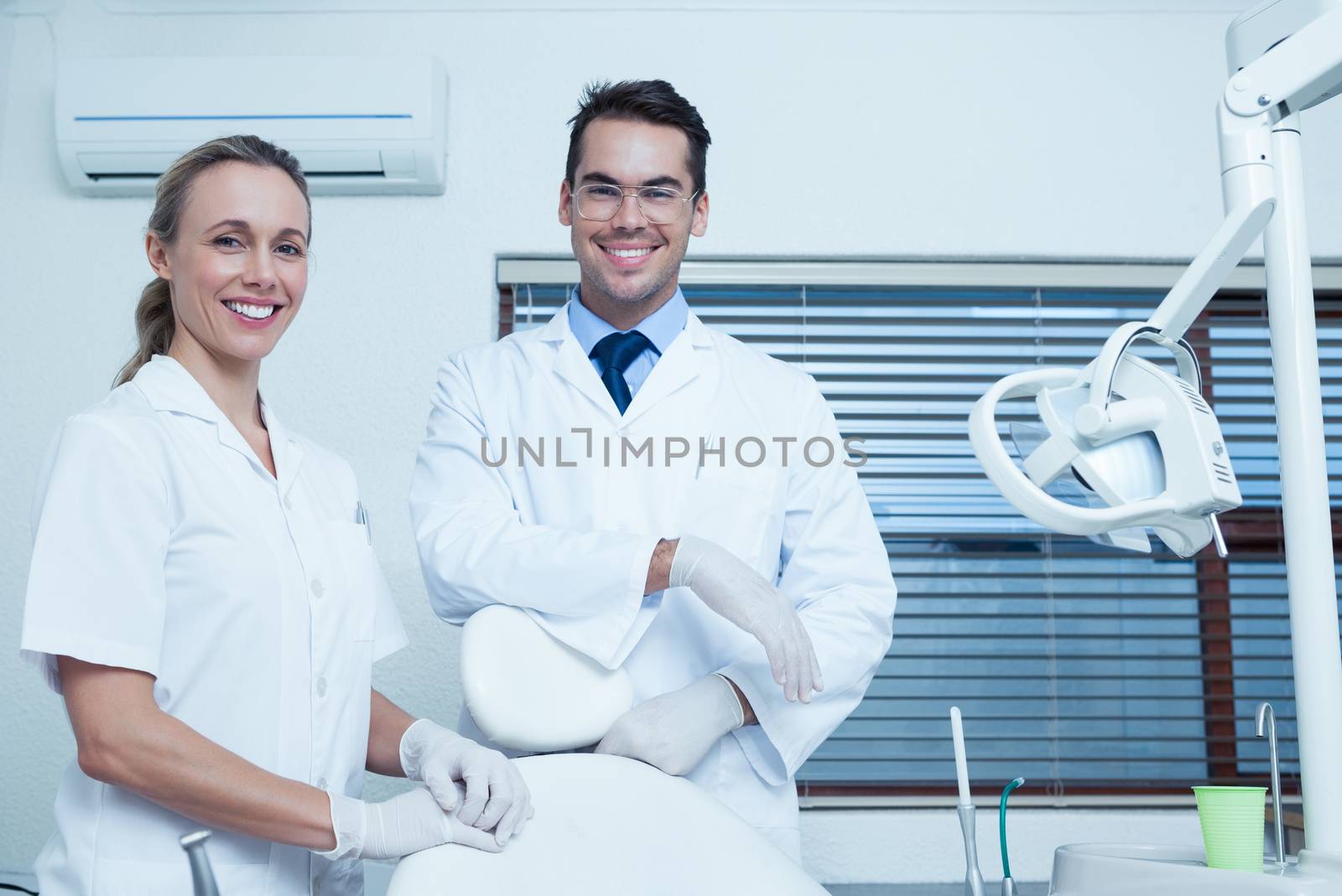 Portrait of smiling male and female dentists