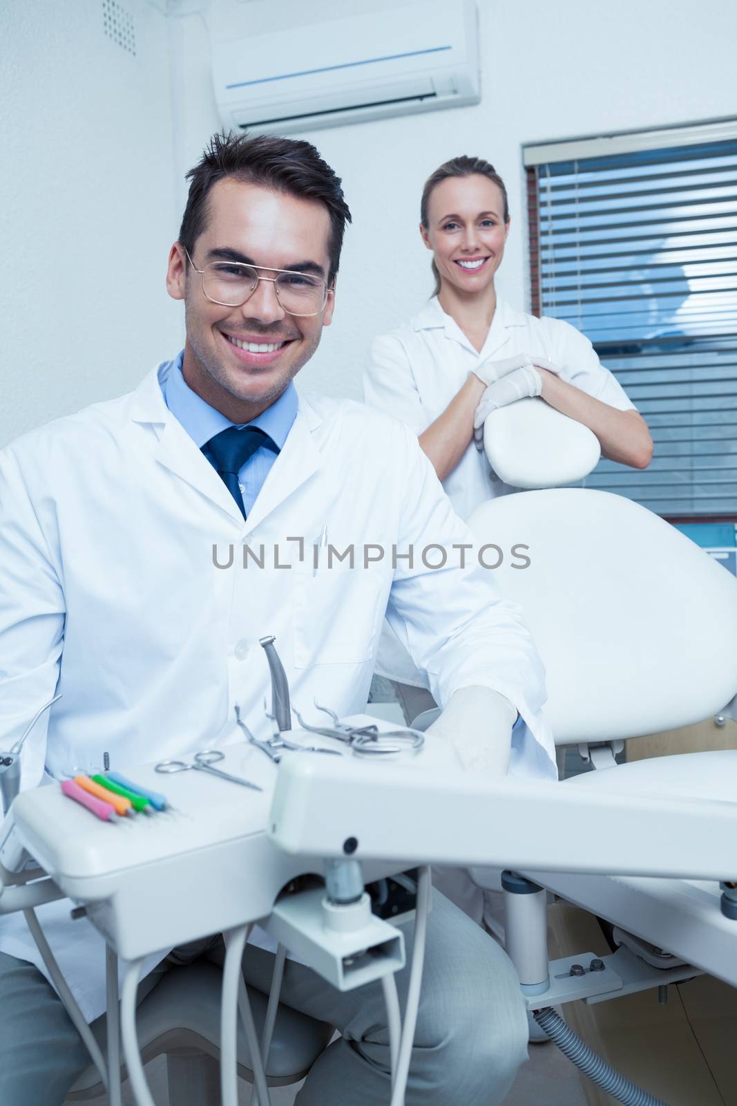 Portrait of smiling male and female dentists