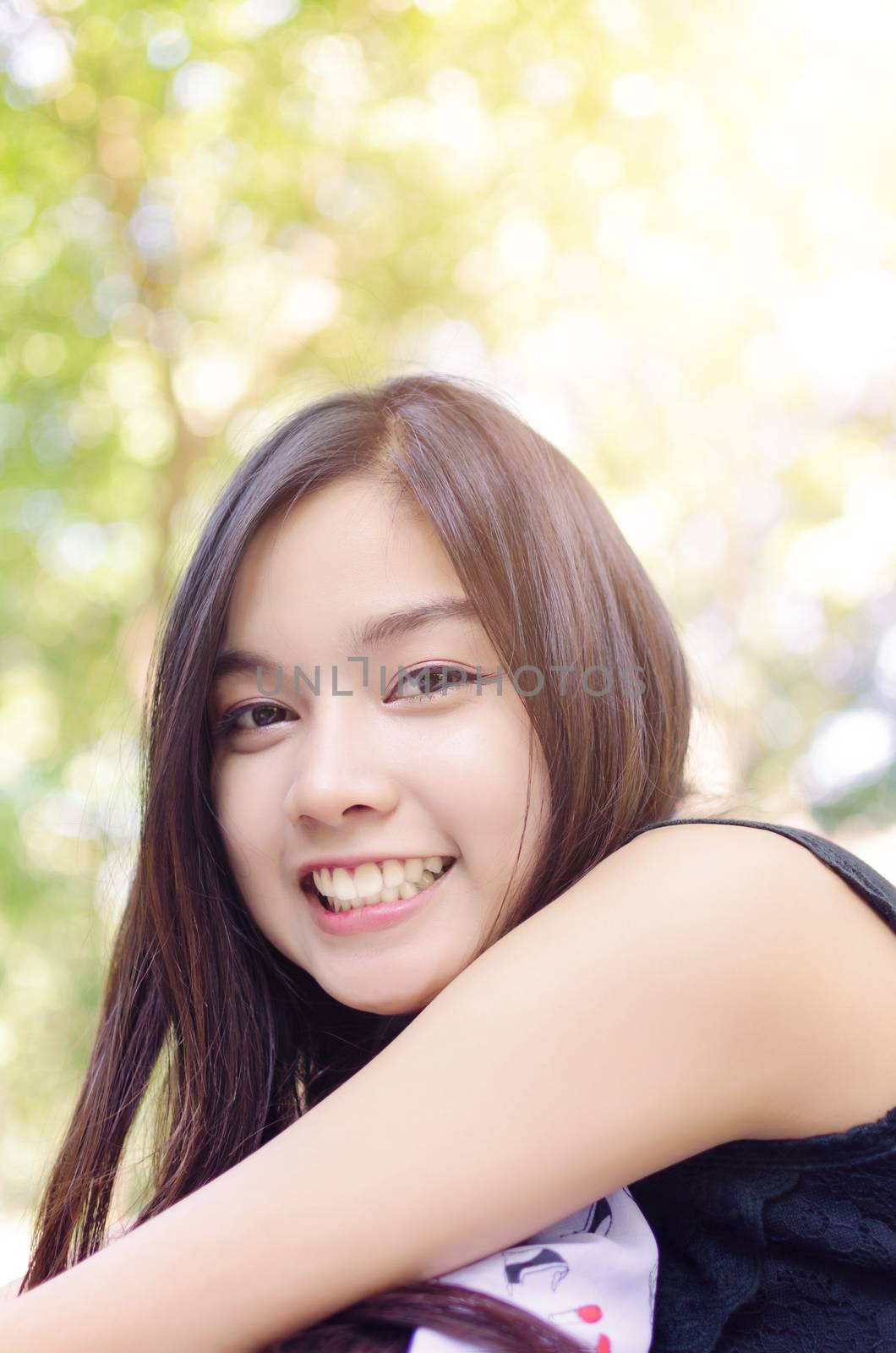 Beautiful asia woman smile with warm light flare effect on top from the sun.