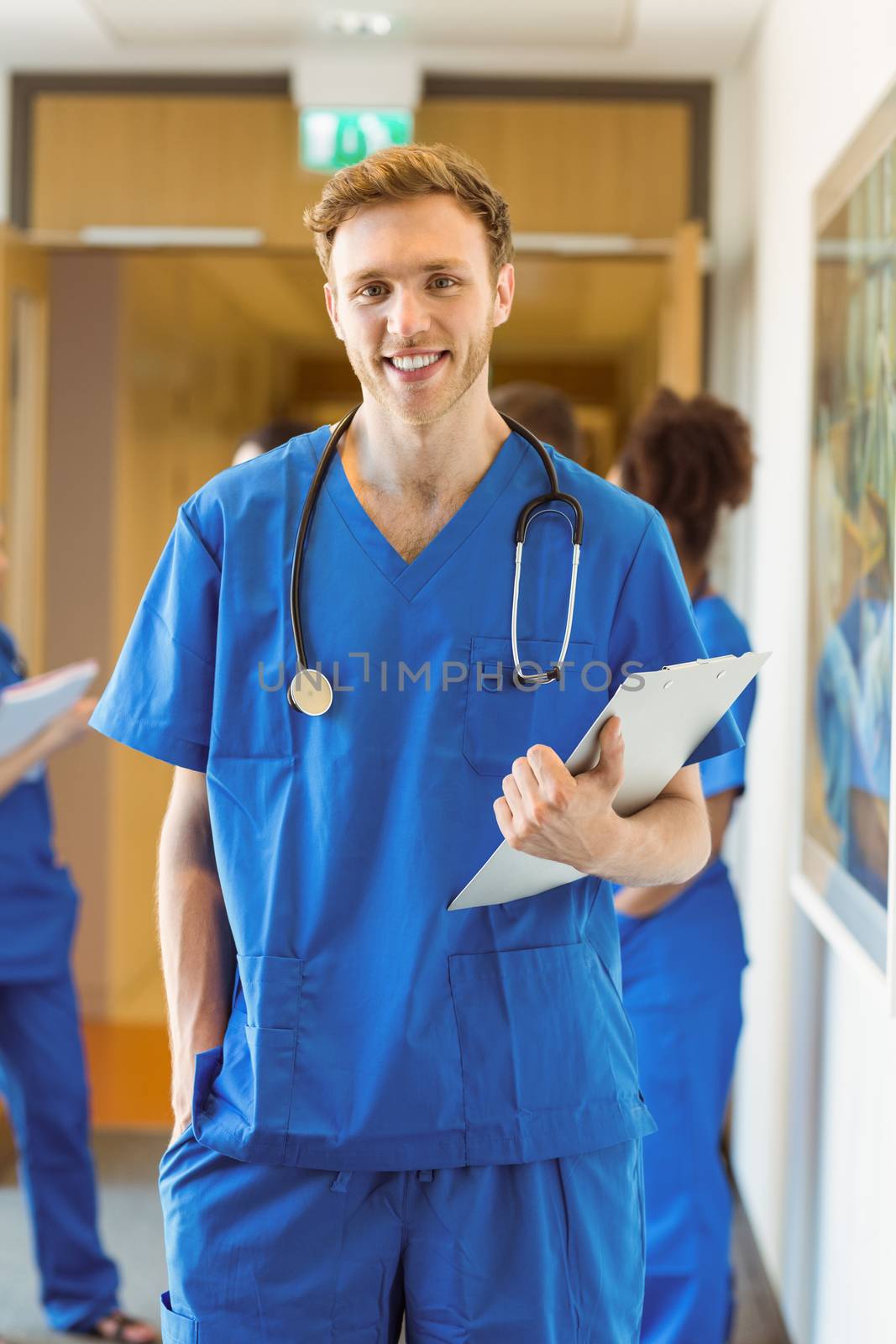 Medical student smiling at the camera by Wavebreakmedia