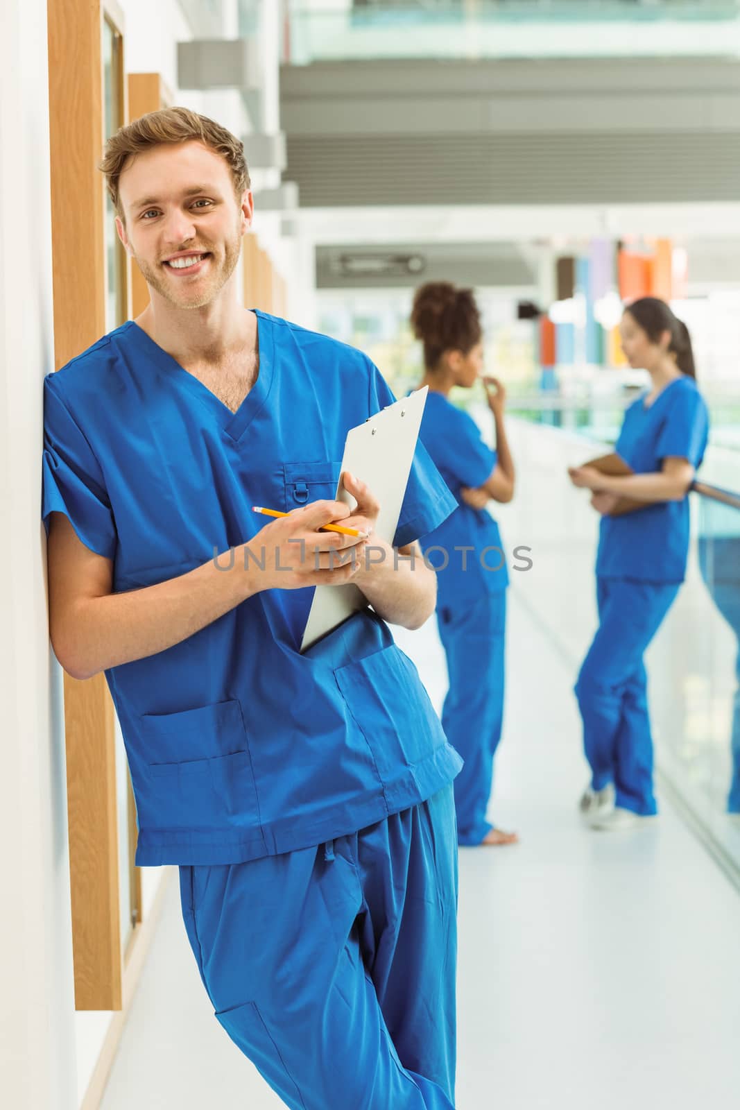 Medical student smiling at camera in hallway by Wavebreakmedia
