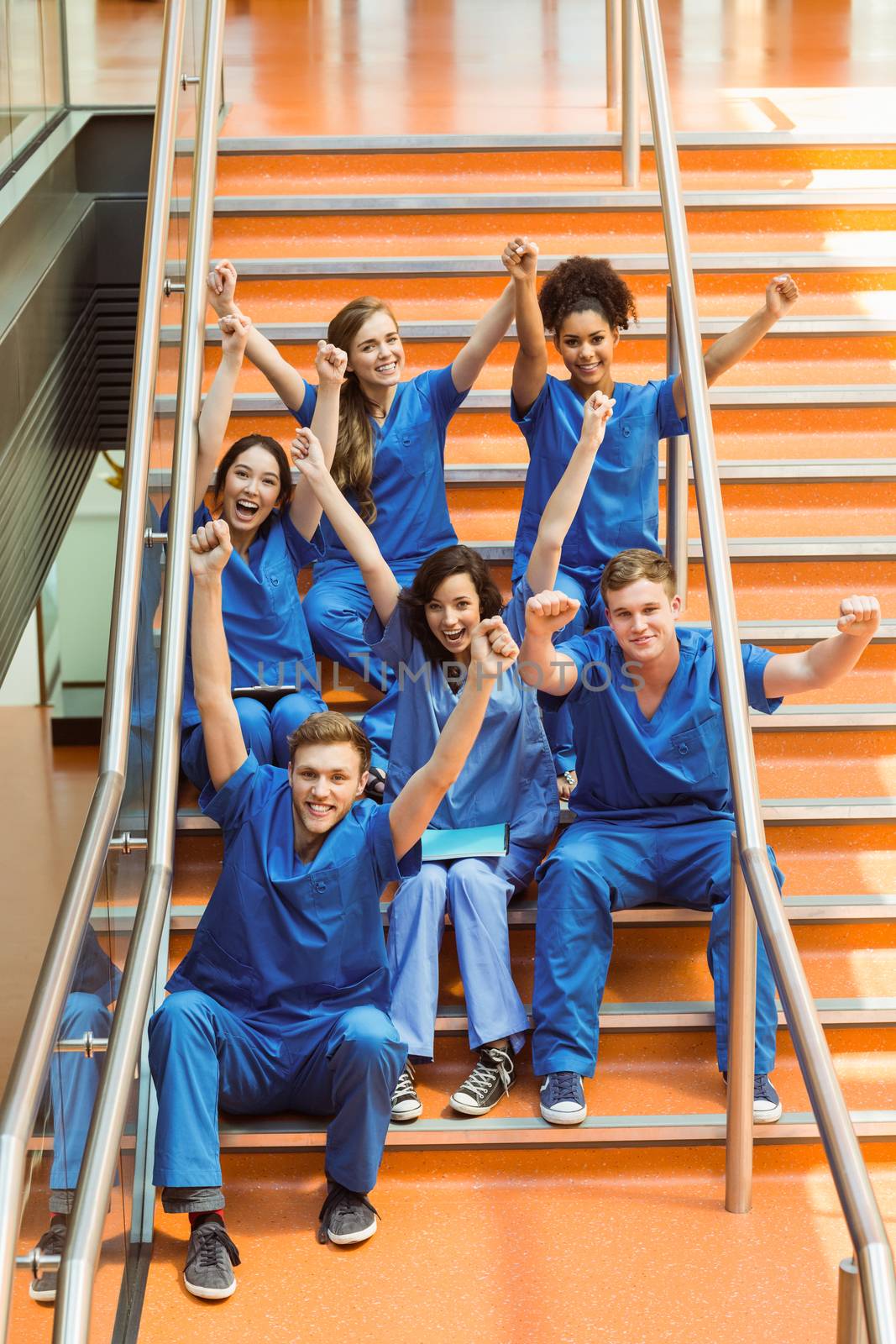 Medical students cheering on the steps at the university