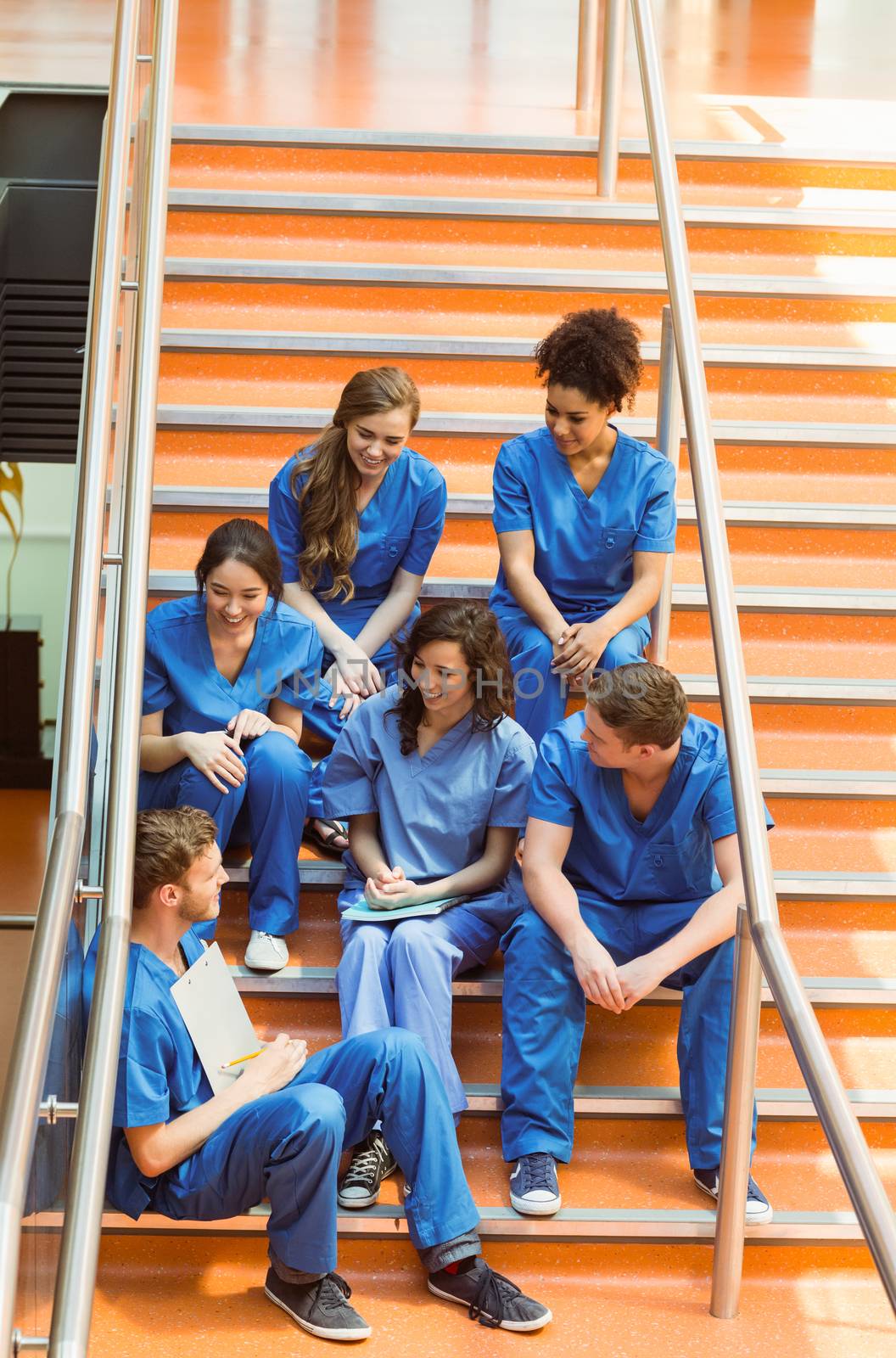 Medical students chatting on the steps by Wavebreakmedia