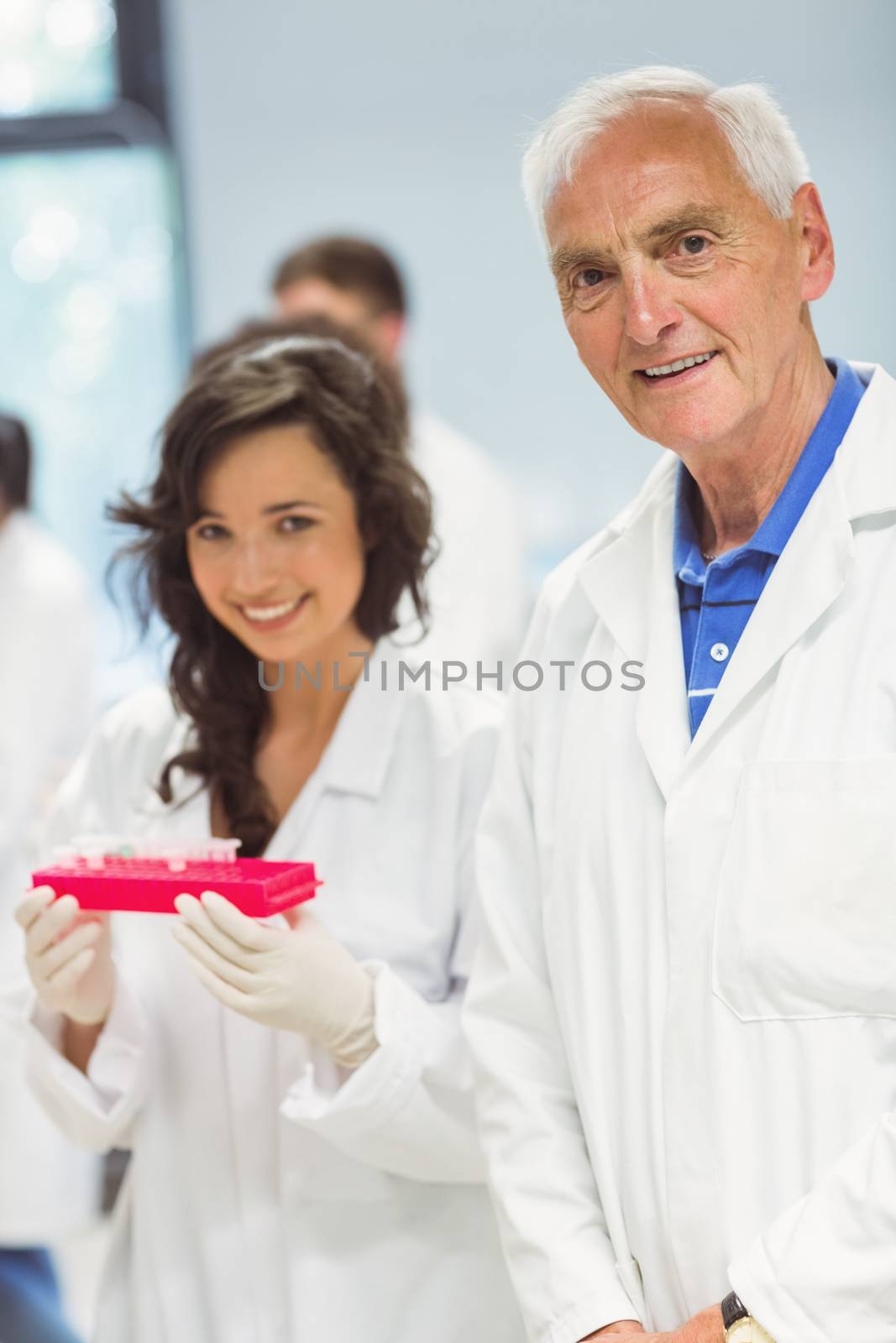 Lecturer and student smiling at camera in the lab at the university