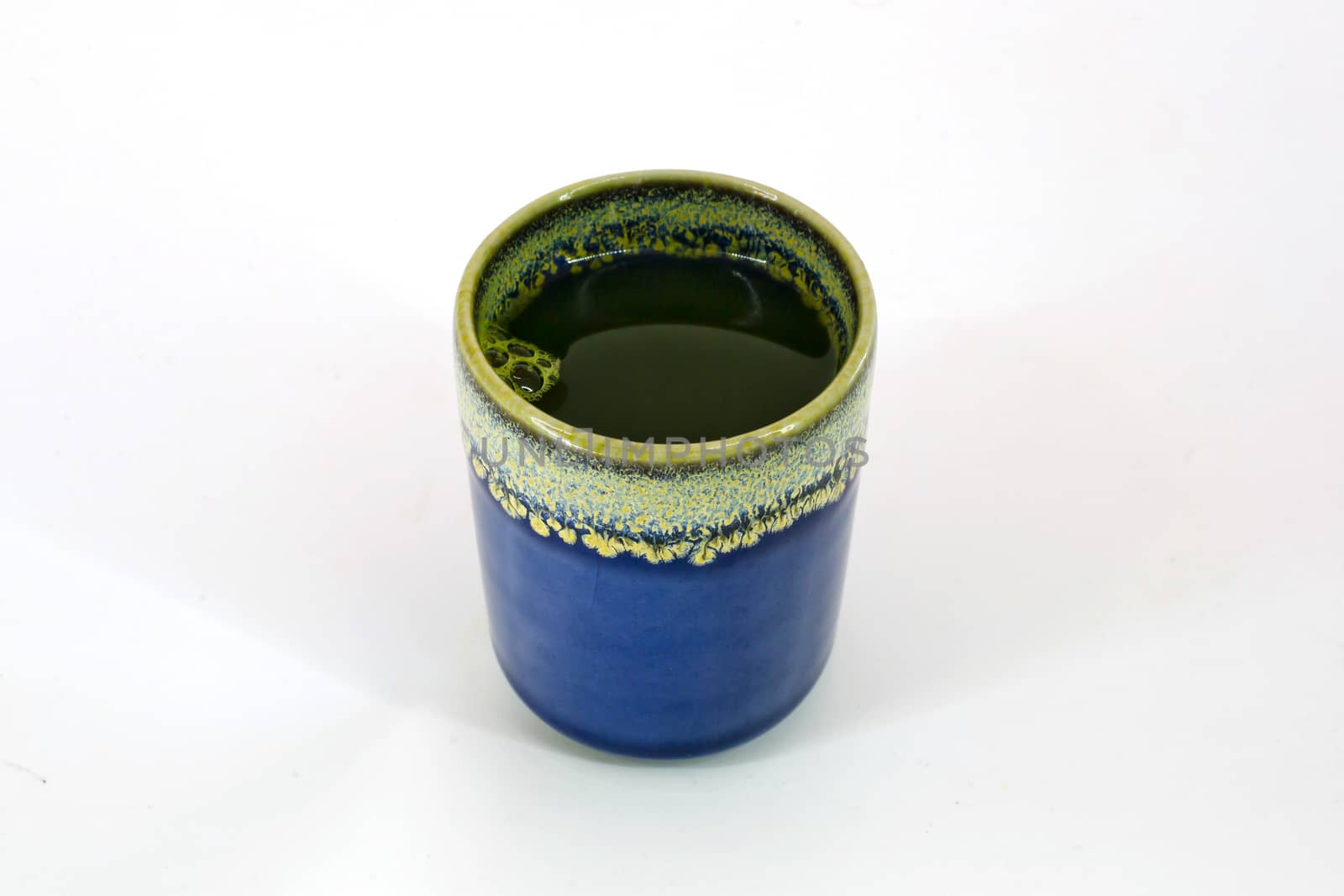 Cup with hot green tea isolate on white background