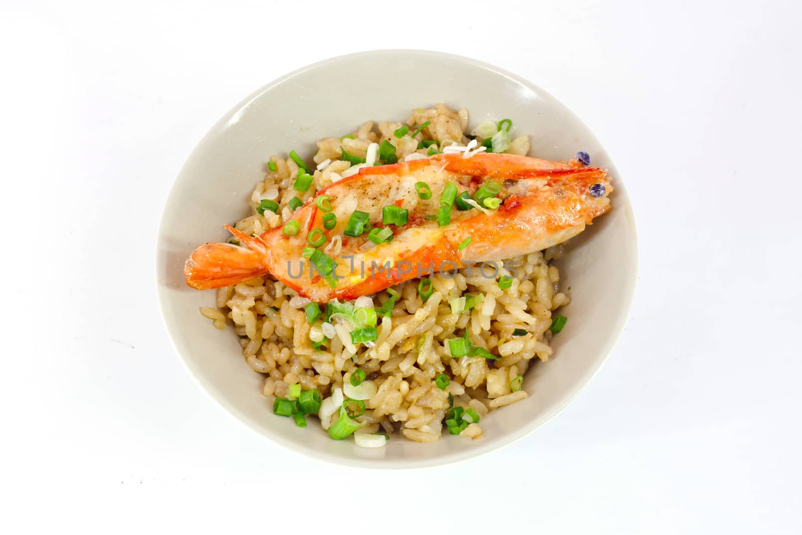 garlic fried rice with prawn sliced and vegetable on top