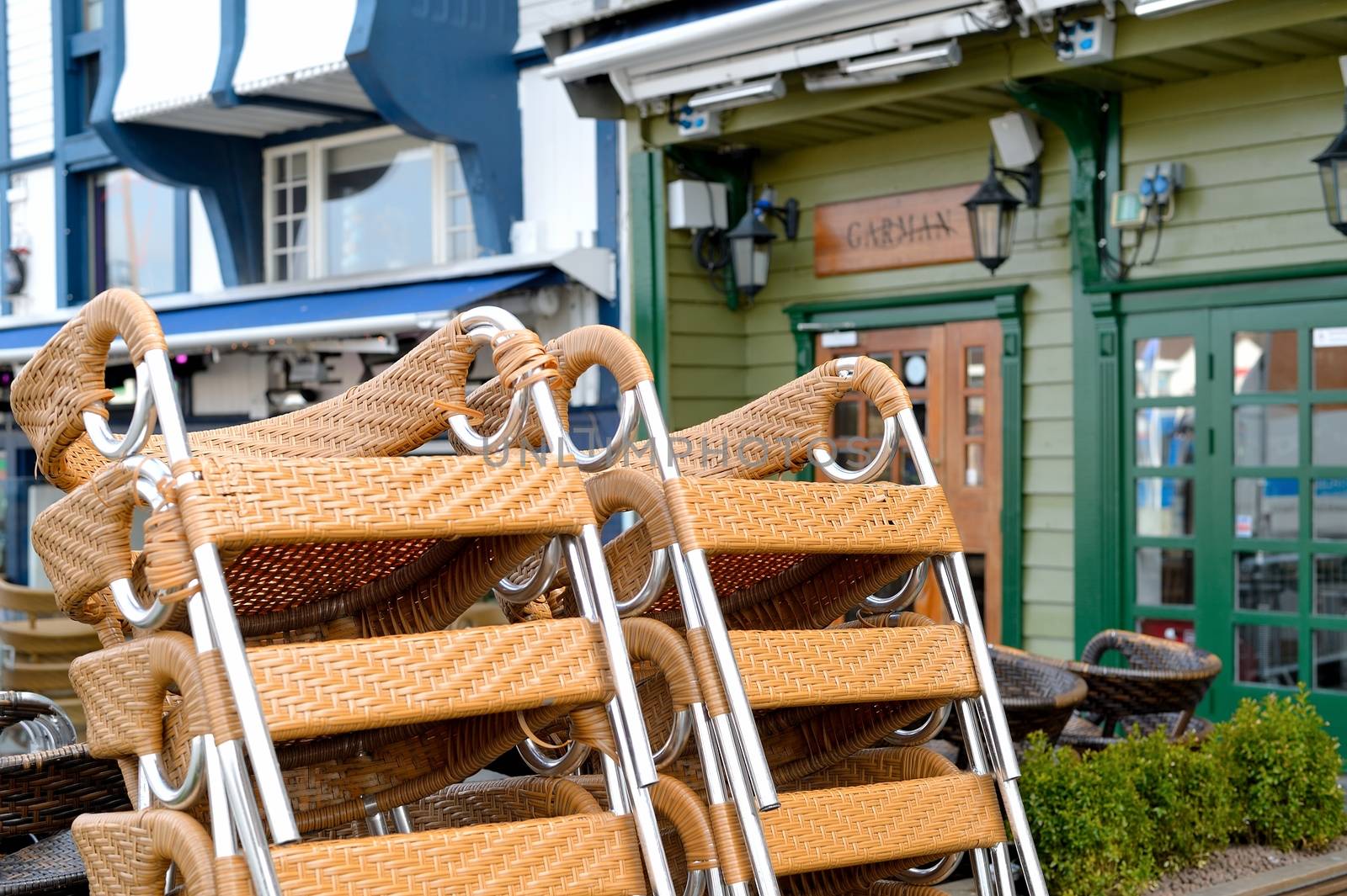 Stack of Chairs Outside a Quayside Resaurant on the Waterfront i by Whiteboxmedia