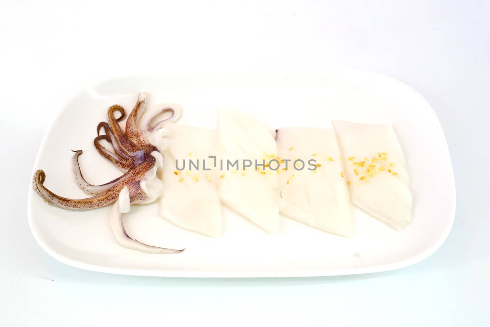 Raw squid slice on white dish isolate on white background ready to be grilled
