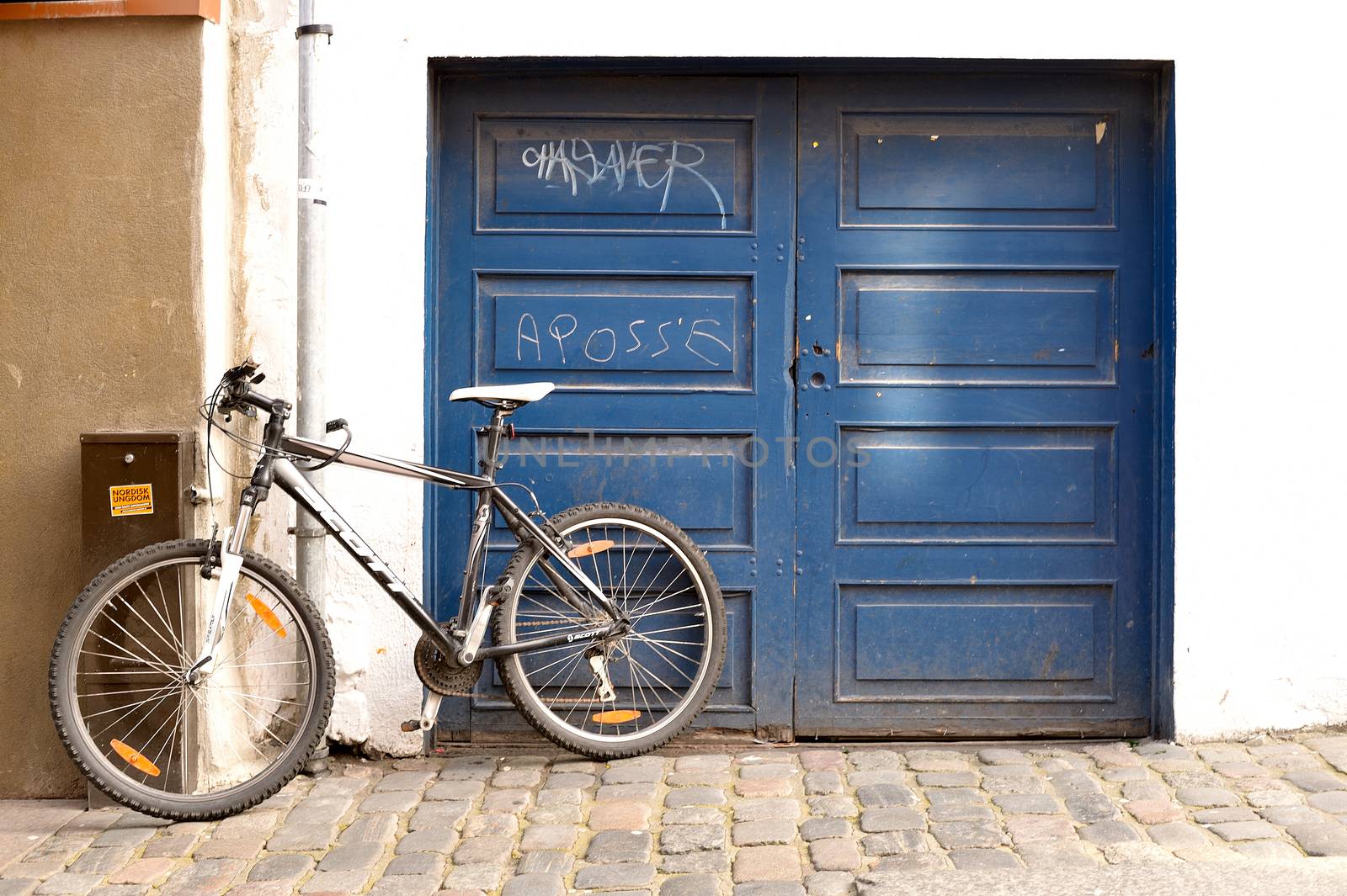 Blue Graffiti Painted Double Garage Door With a Bicycle Leaning Against Skagen Stavanger Norway