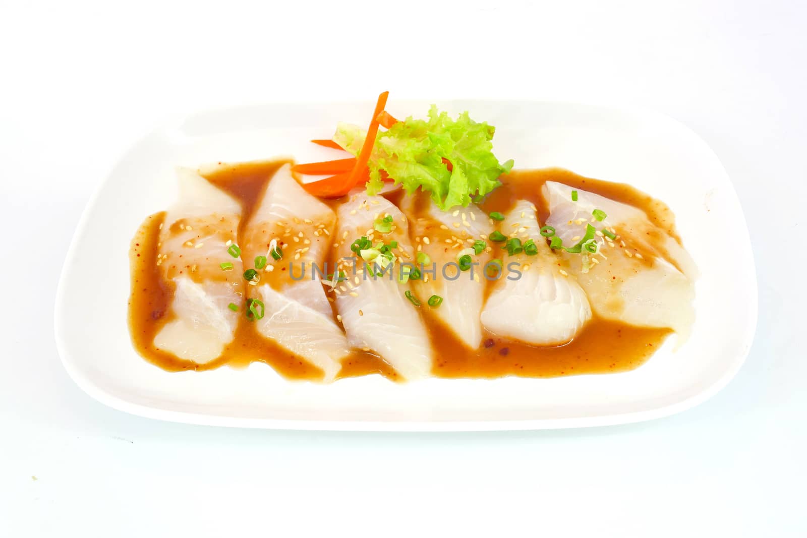 Fresh Dolly fish slice on white dish isolate on white background ready to be grilled.