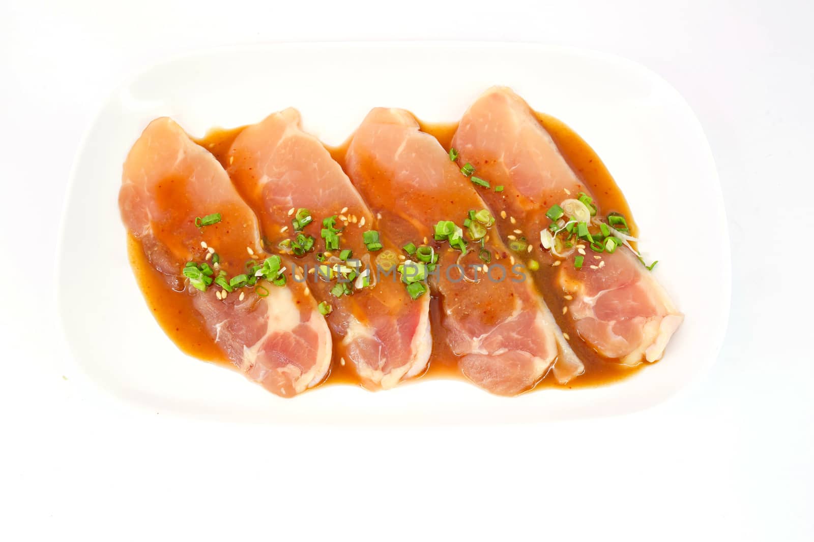 Fresh slices of chicken isoloate on white background ready to be grilled.