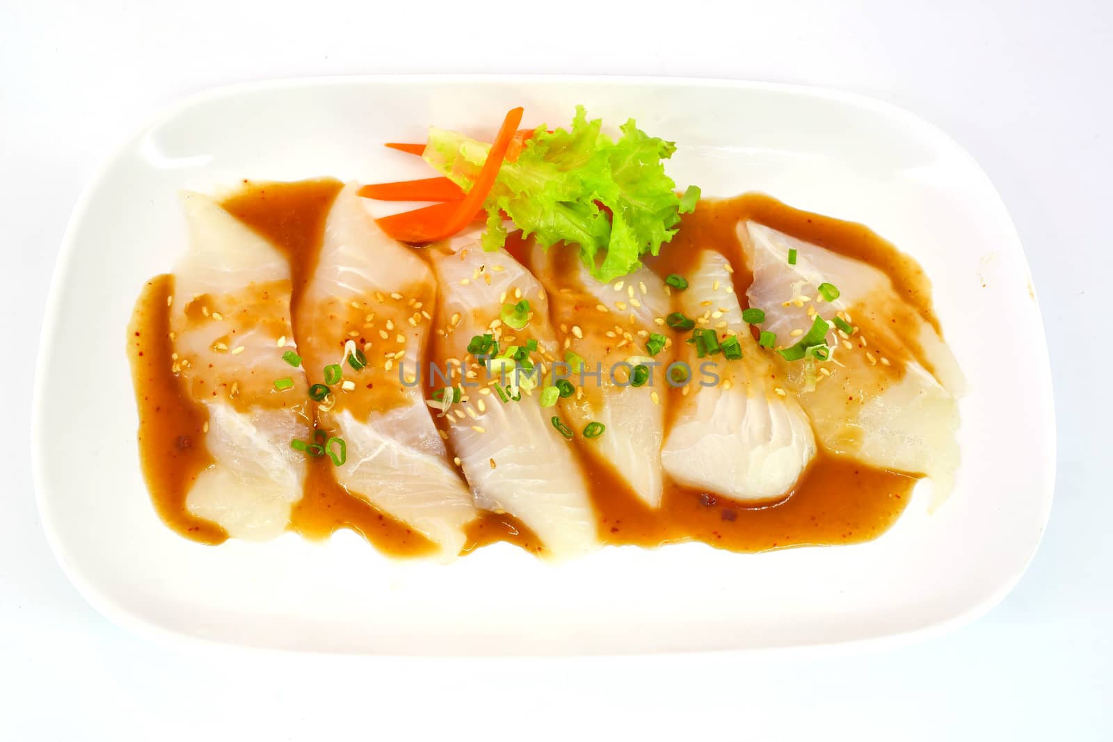 Fresh Dolly fish slice on white dish isolate on white background ready to be grilled.