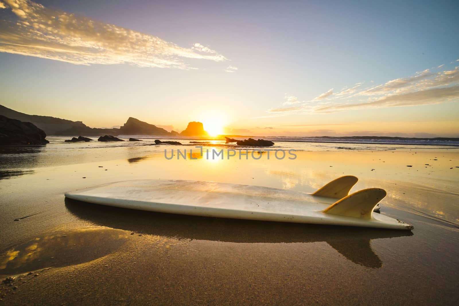 Silhouette of a surfboard at the beach with reflection 