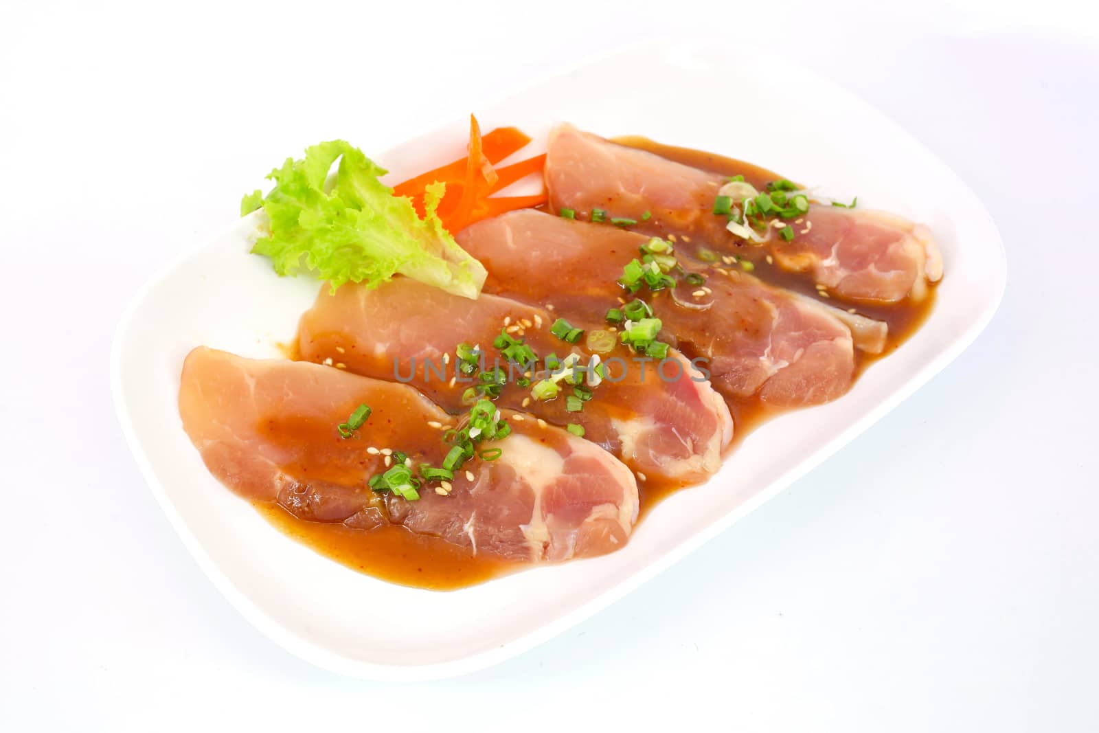 Fresh slices of chicken isoloate on white background ready to be grilled.