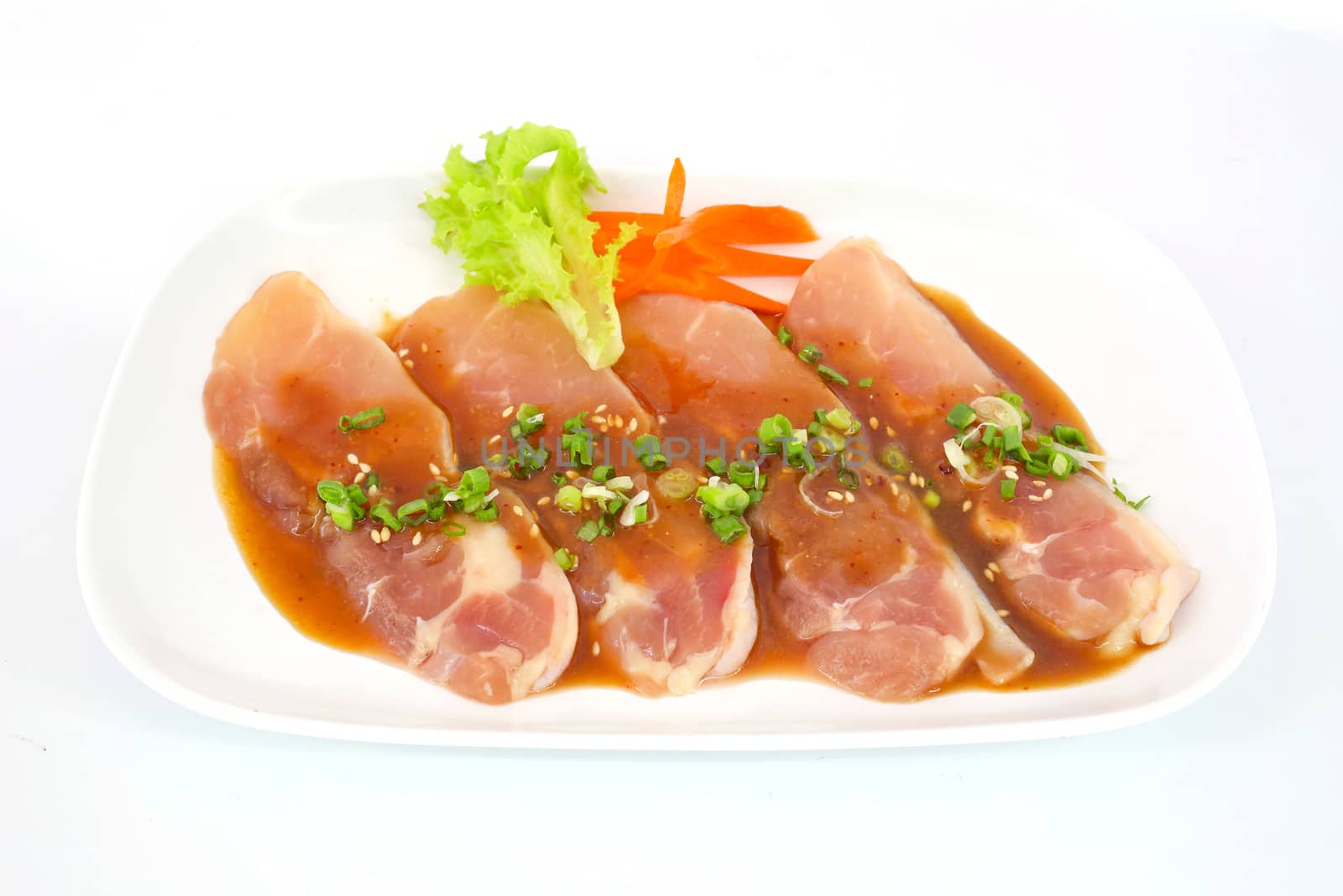 Fresh slices of chicken isoloate on white background ready to be grilled.