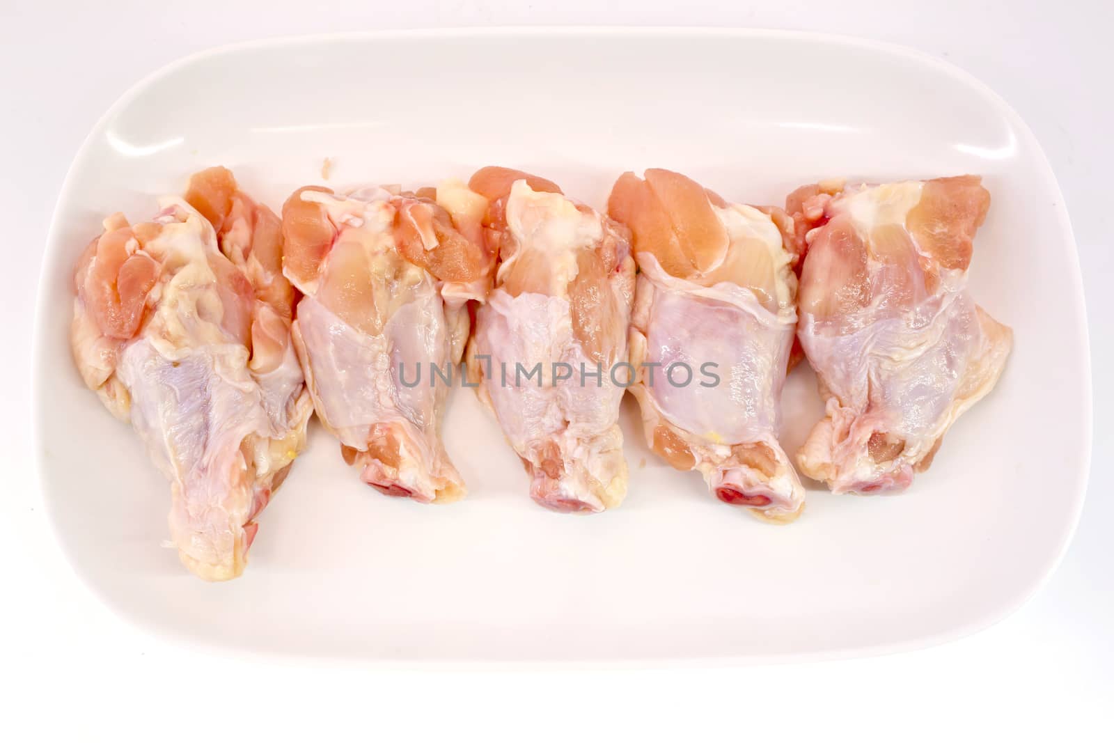 Fresh raw chicken wings isolate on white background ready to be grilled