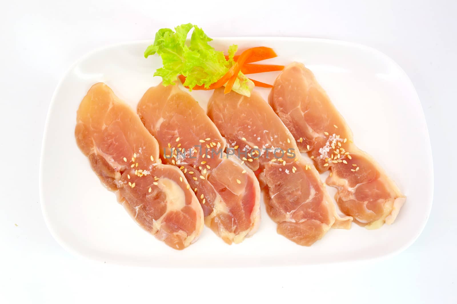 Fresh slices of chicken isoloate on white background ready to be grilled.