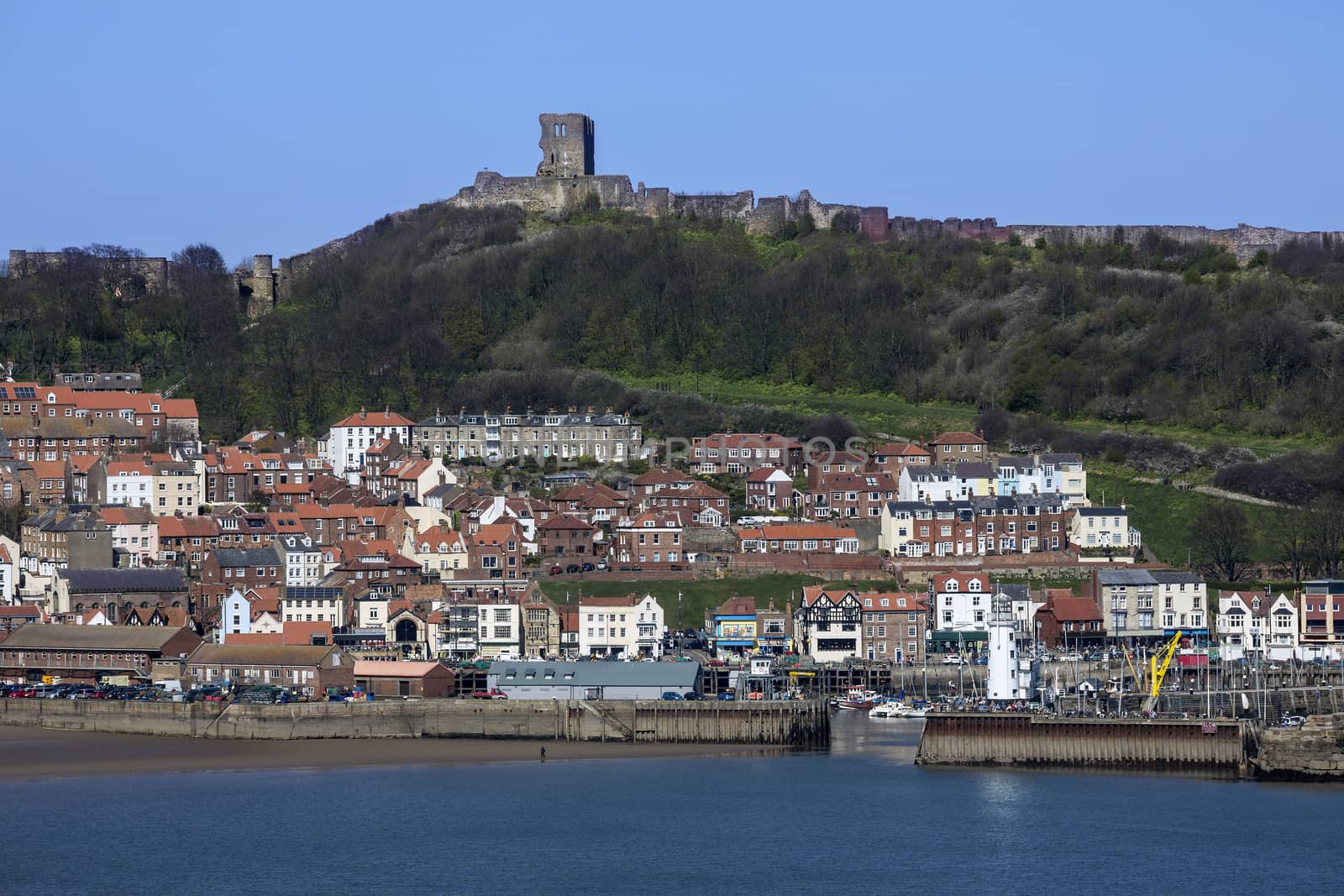 Scarborough Castle on a hillside above the town and harbor - North Yorkshire coast in the northeast of England.