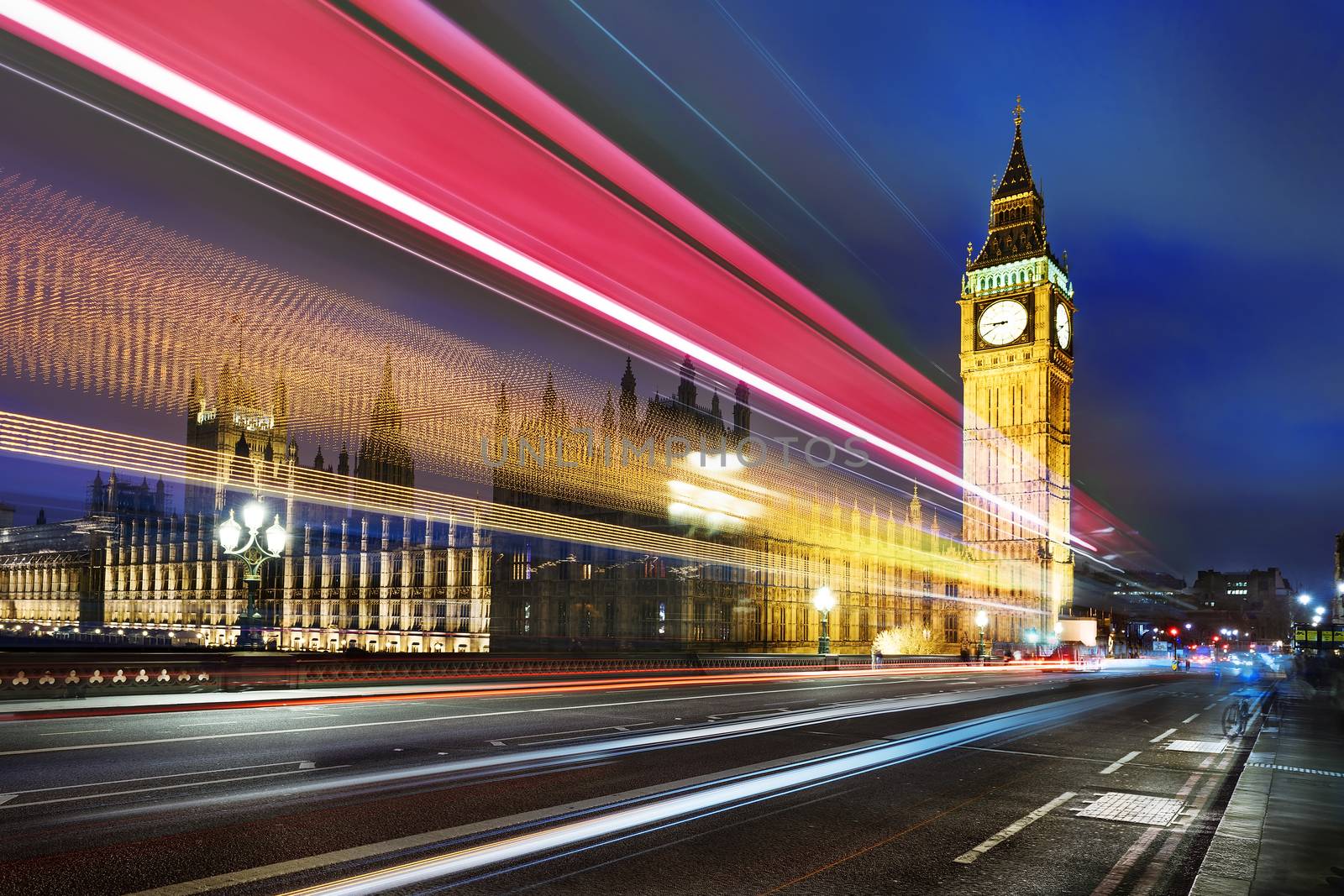 Big Ben, one of the most prominent symbols of both London and England, as shown at night along with the lights of the cars passing 