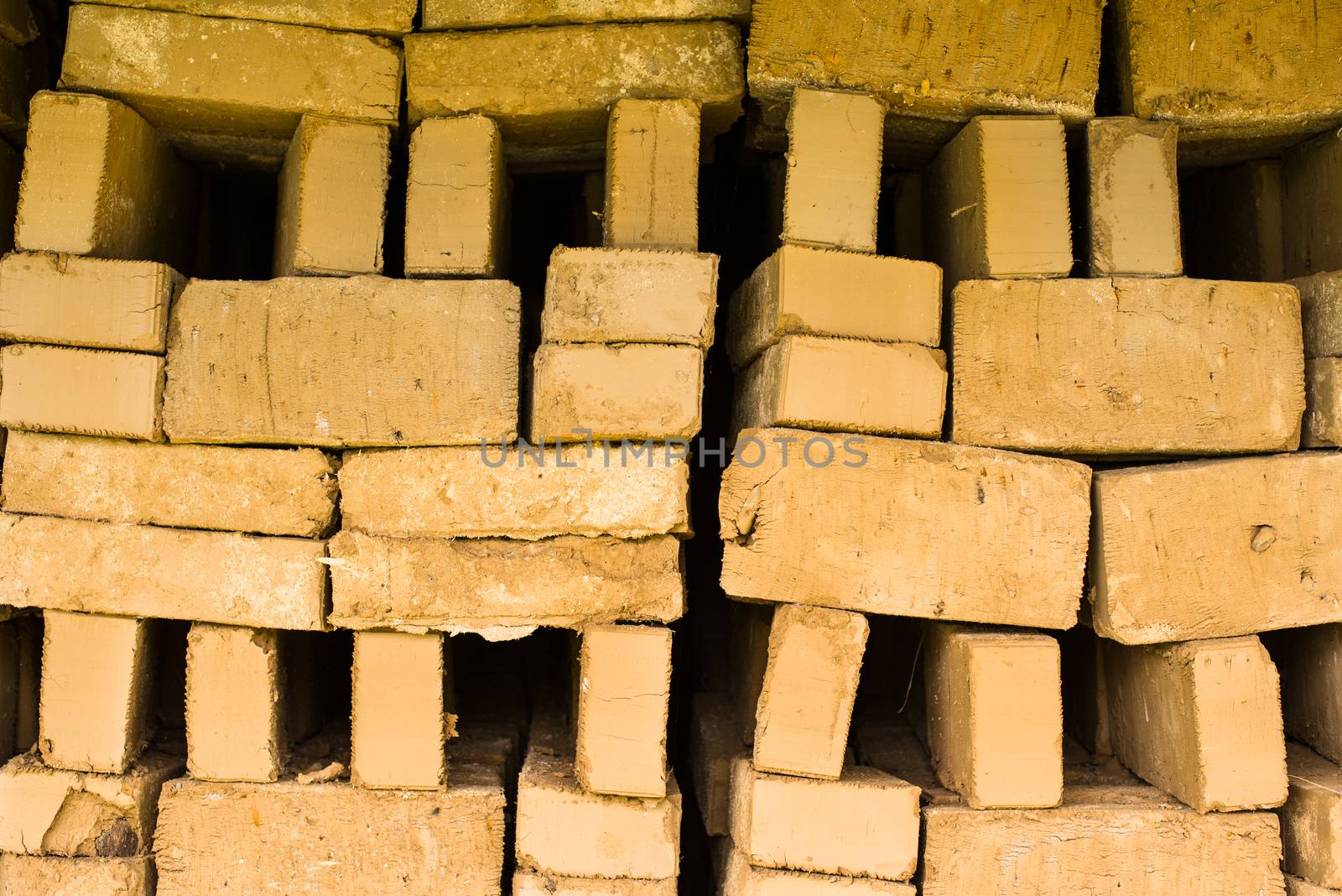 Stack of raw bricks drying in the open air.