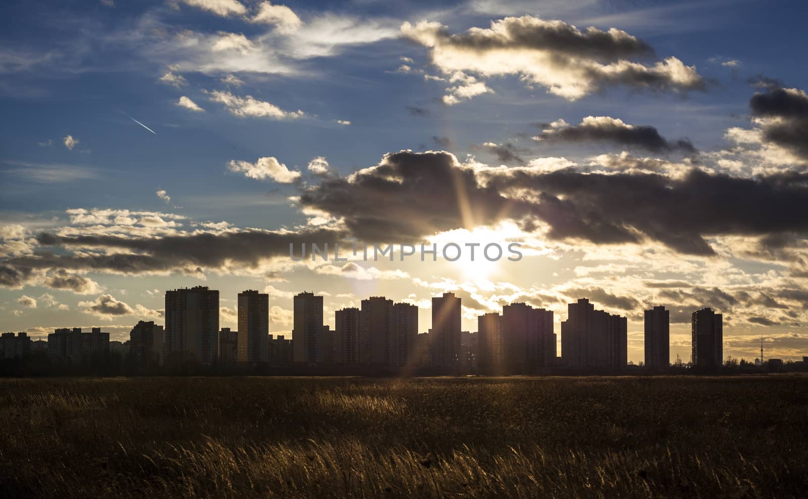 Urban landscape. Silhouettes of Kyiv (Ukraine) high-rise buildings against the sun
