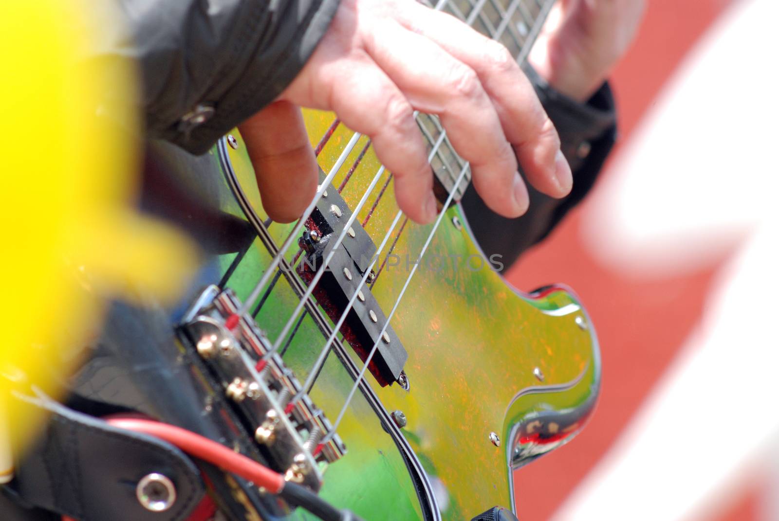 Pictire of a guitarist plays electric bass