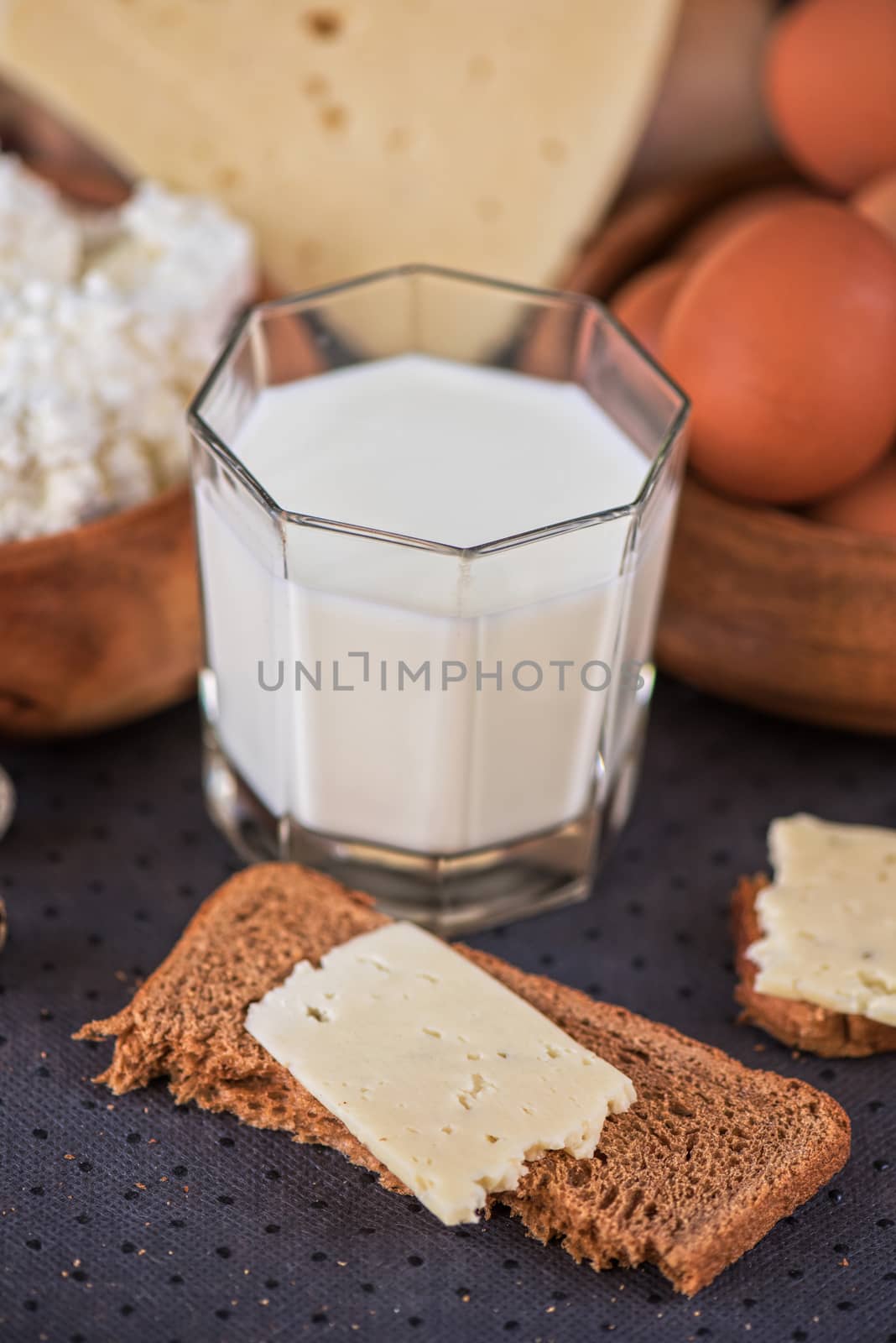 still life with dairy products as milk, cheese cottage cheese eggs and bread 