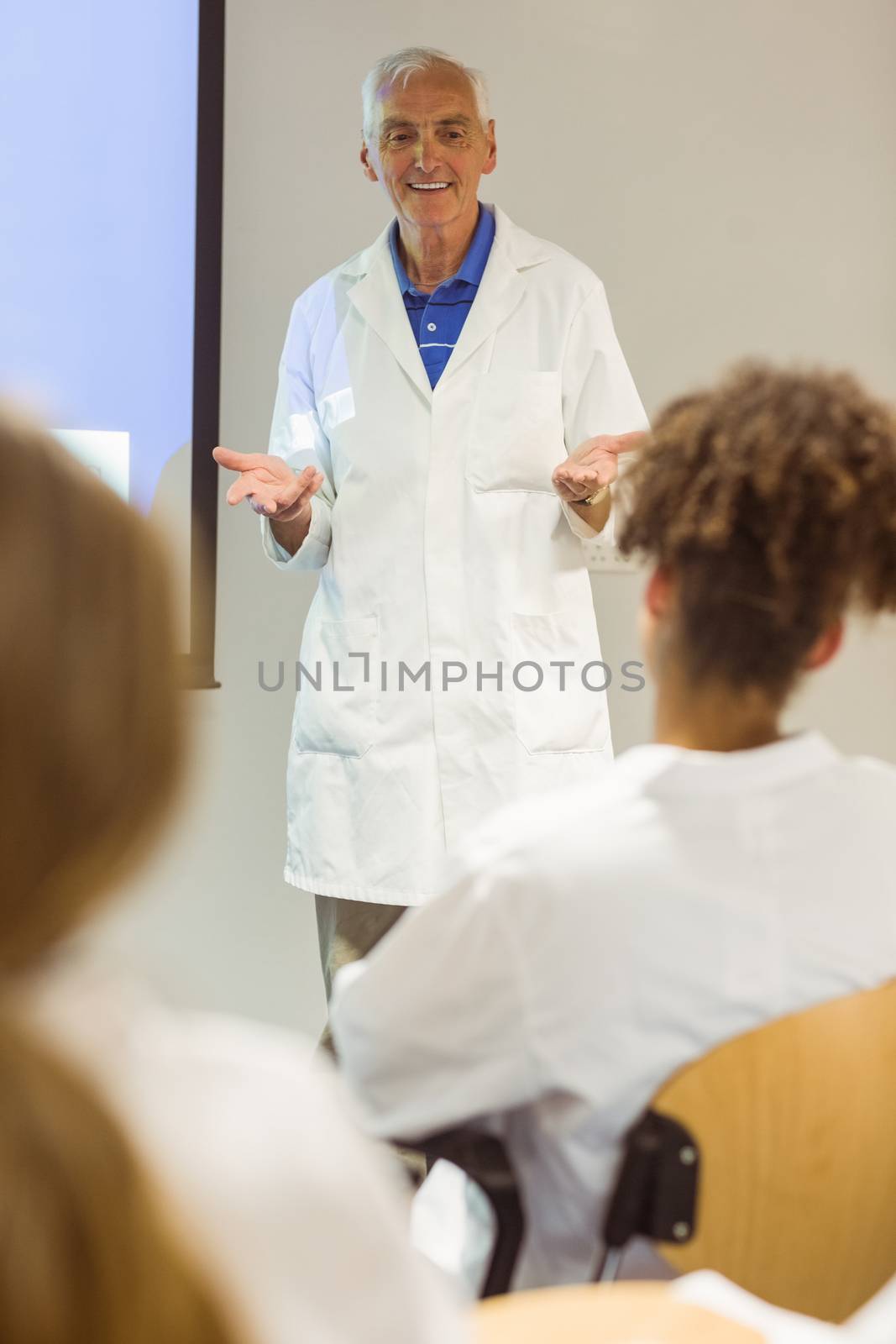 Science professor giving lecture to class by Wavebreakmedia