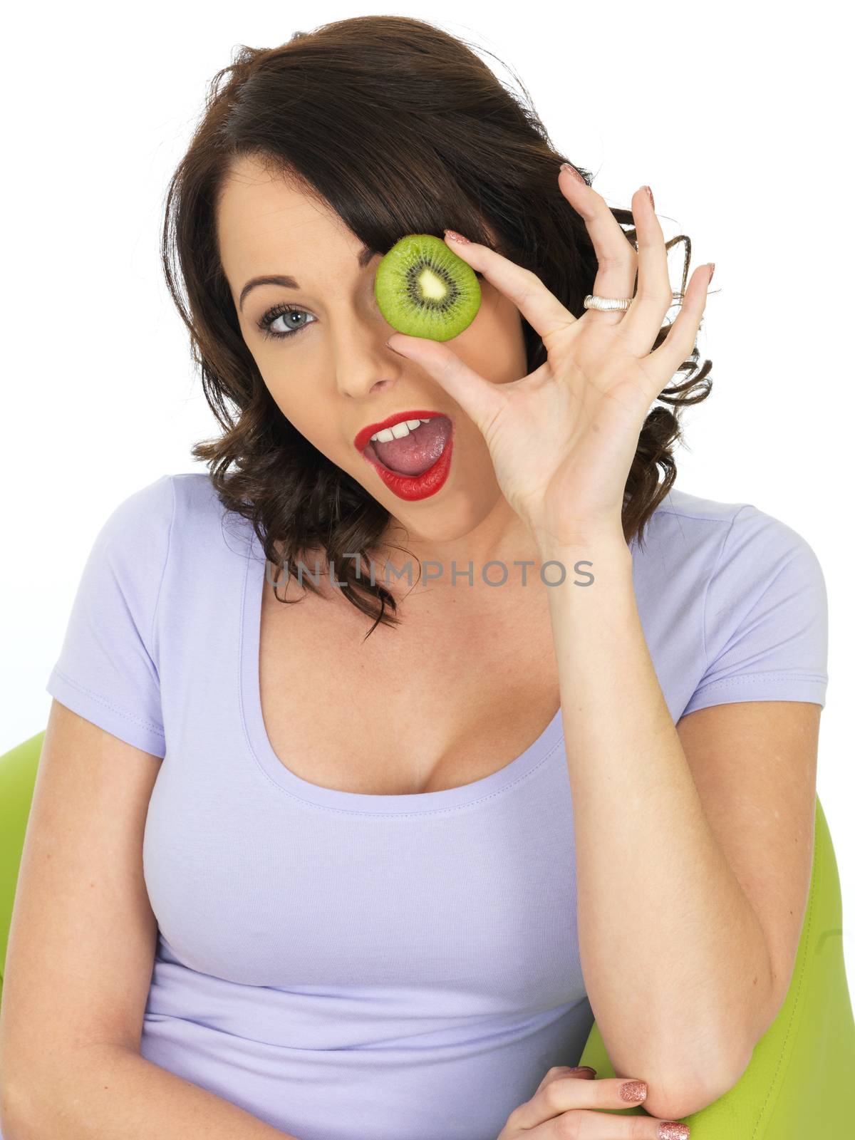 Young Woman Holding Fresh Ripe Kiwi Fruit by Whiteboxmedia