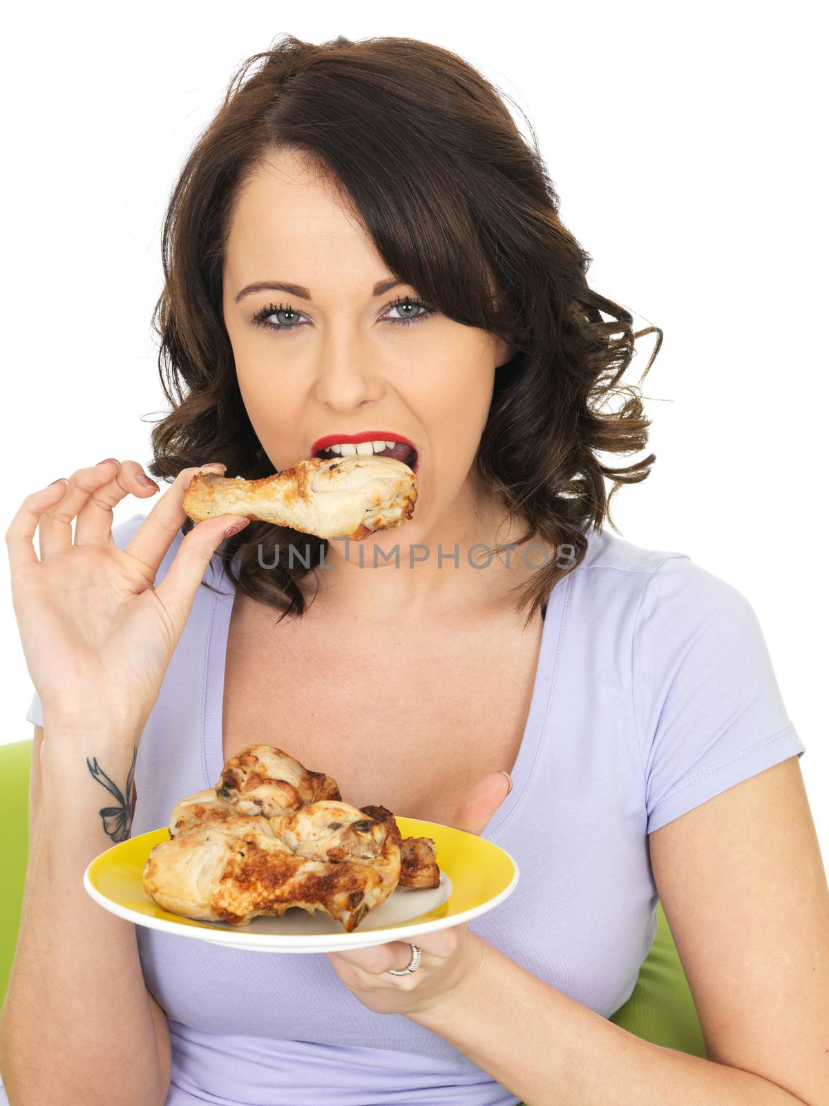 Young Woman Eating Cold Cooked Chicken Legs by Whiteboxmedia