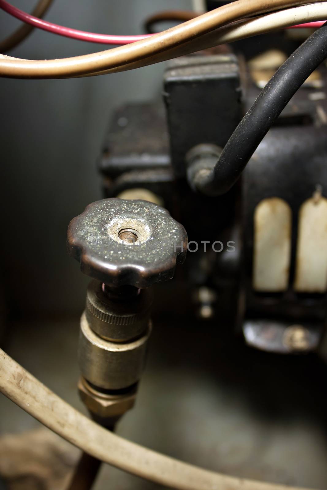 Furnace oil shut off line valve on a home furnace. Shallow depth of field.