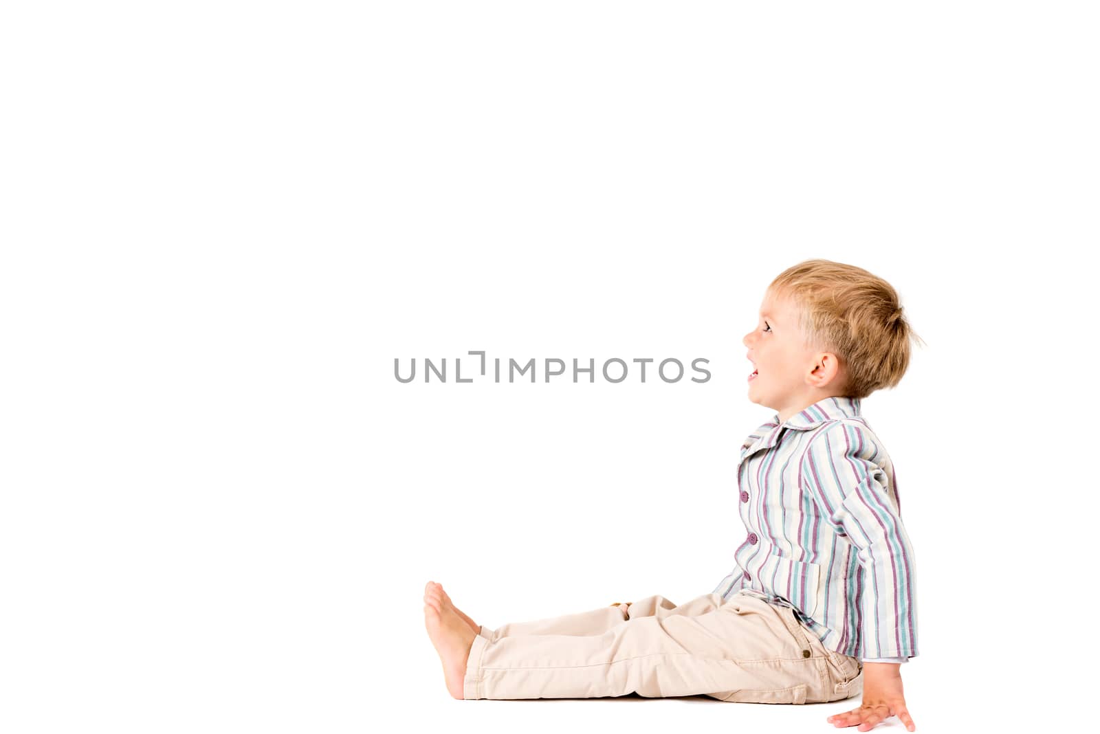 Boy shot in the studio on a white background with copy space by Nanisimova