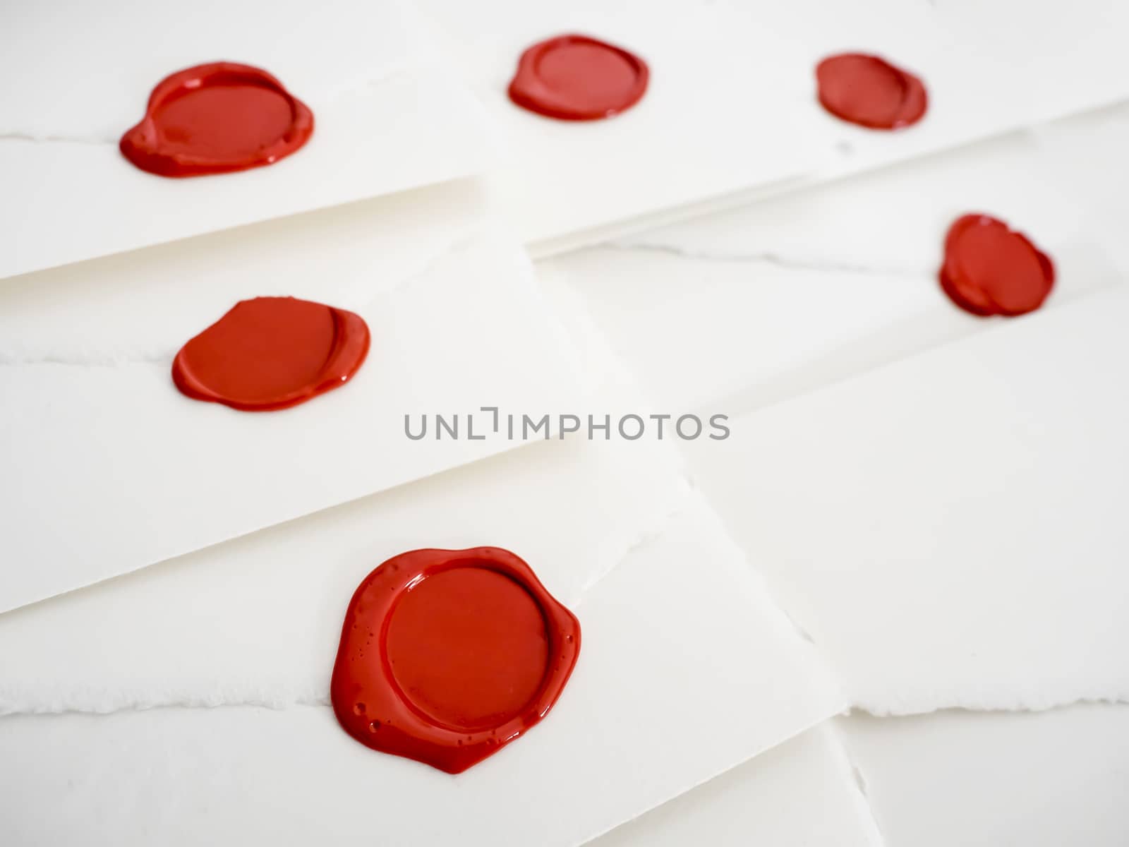 group of white letters with red sealing wax by rigamondis