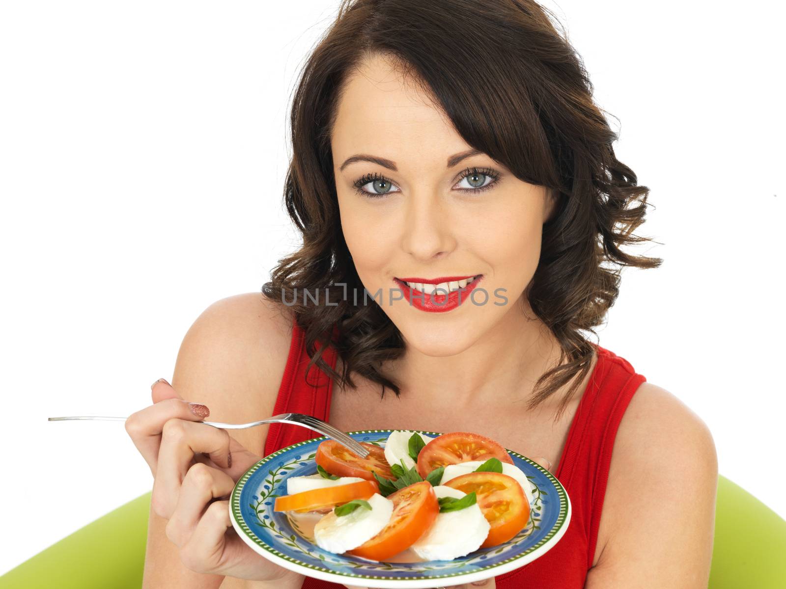 Young Healthy Woman Eating a Mozzarella Cheese and Tomato Salad