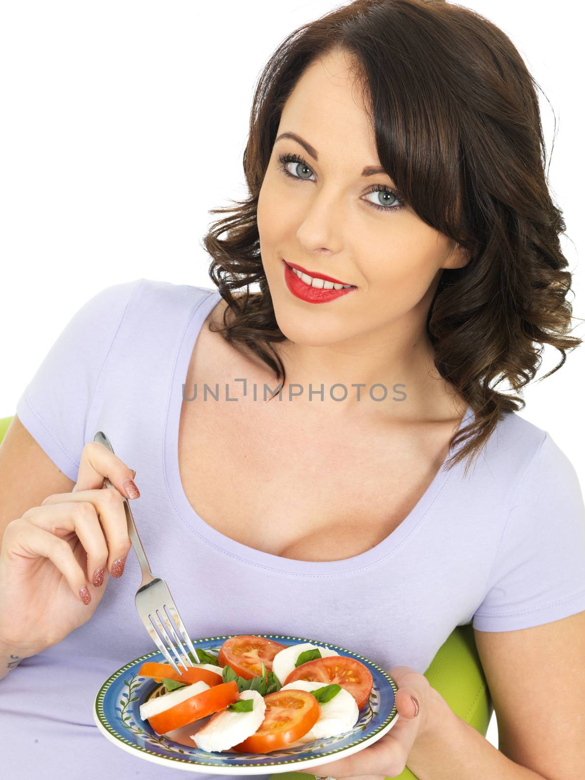 Young Healthy Woman Eating a Mozzarella Cheese and Tomato Salad