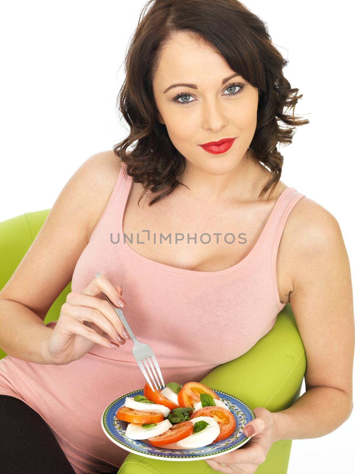Young Healthy Woman Eating a Mozzarella Cheese and Tomato Salad
