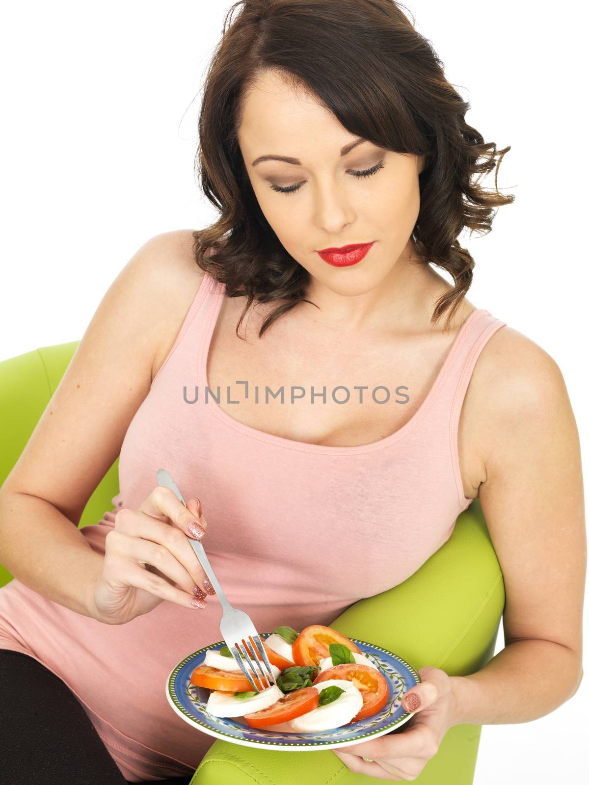 Young Woman Eating a Mozzarella Cheese and Tomato Salad by Whiteboxmedia